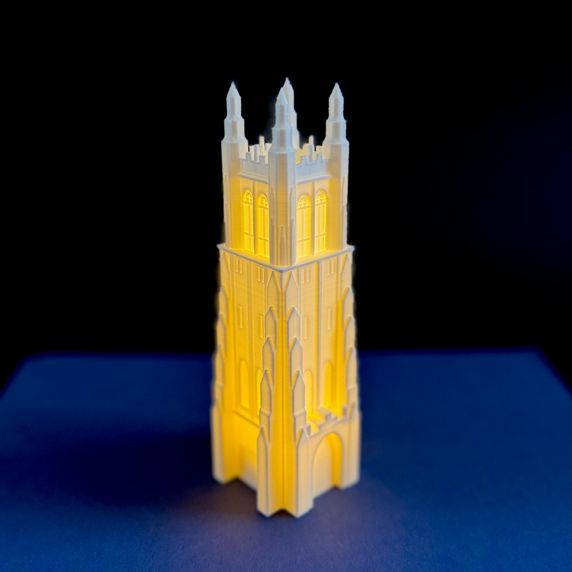 The Duke Chapel night light, shown against a blue background.