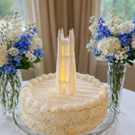 The Duke University cake topper, designed as a reusable figurine representing the Duke Chapel building and with an LED light.
