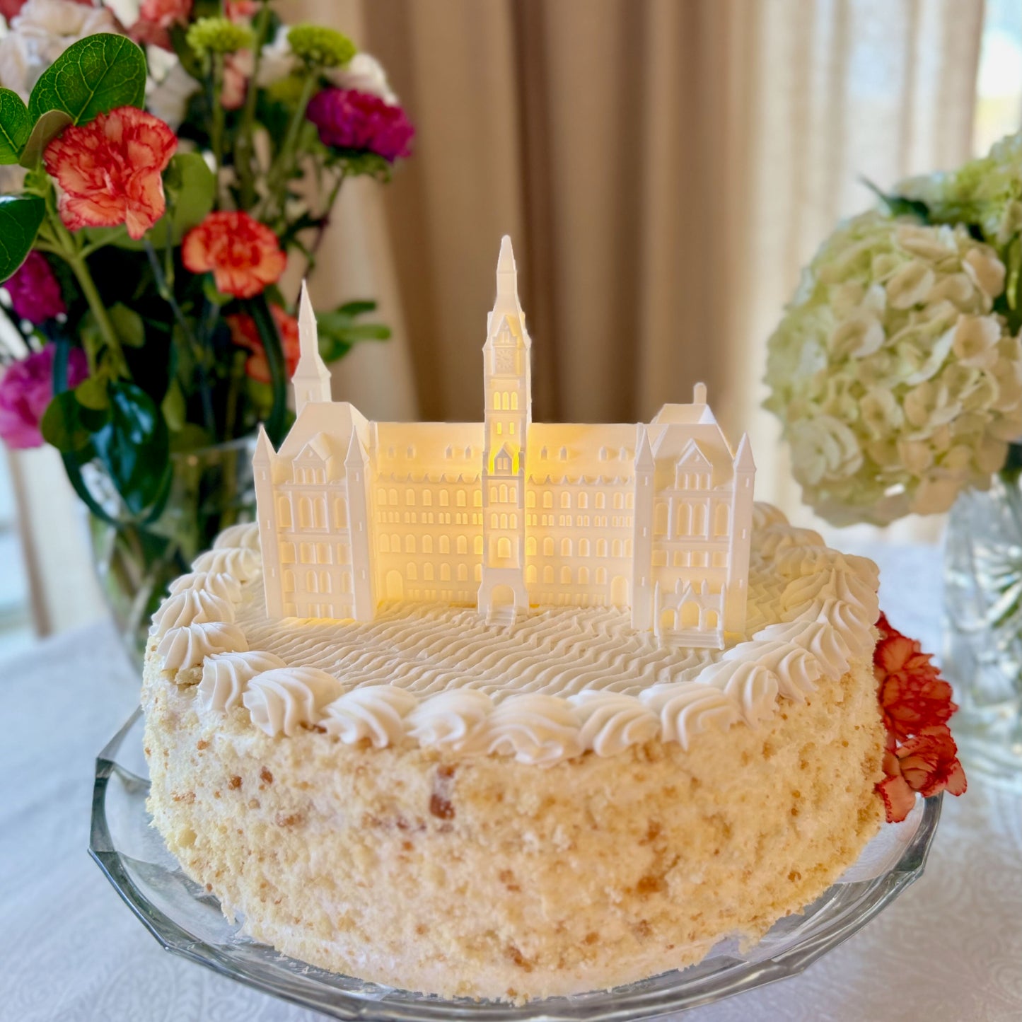 A Georgetown Groom's Cake with a lighted cake topper representing the Healy Hall building.