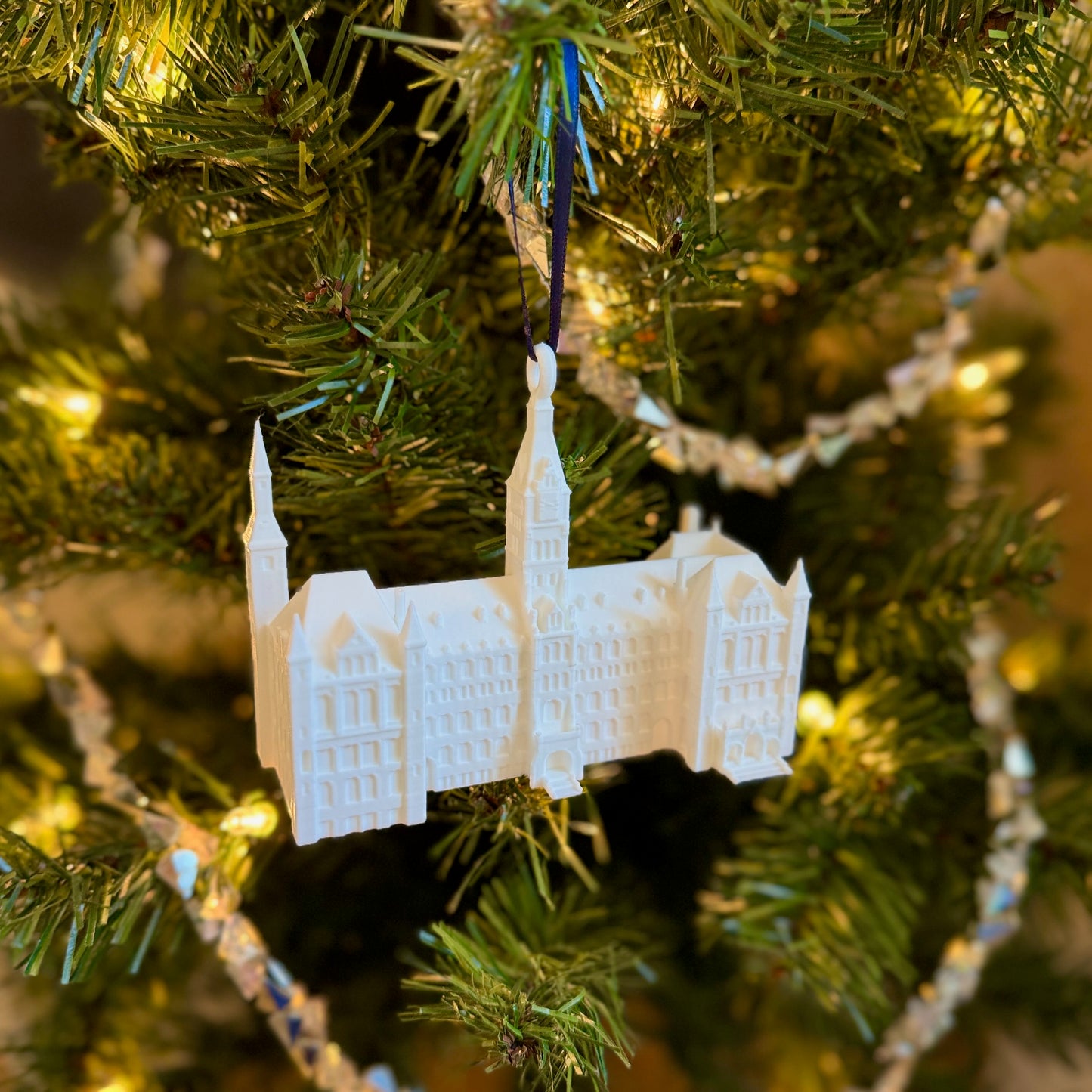 The Georgetown Ornament featuring Healy Hall, shown on a Christmas tree.