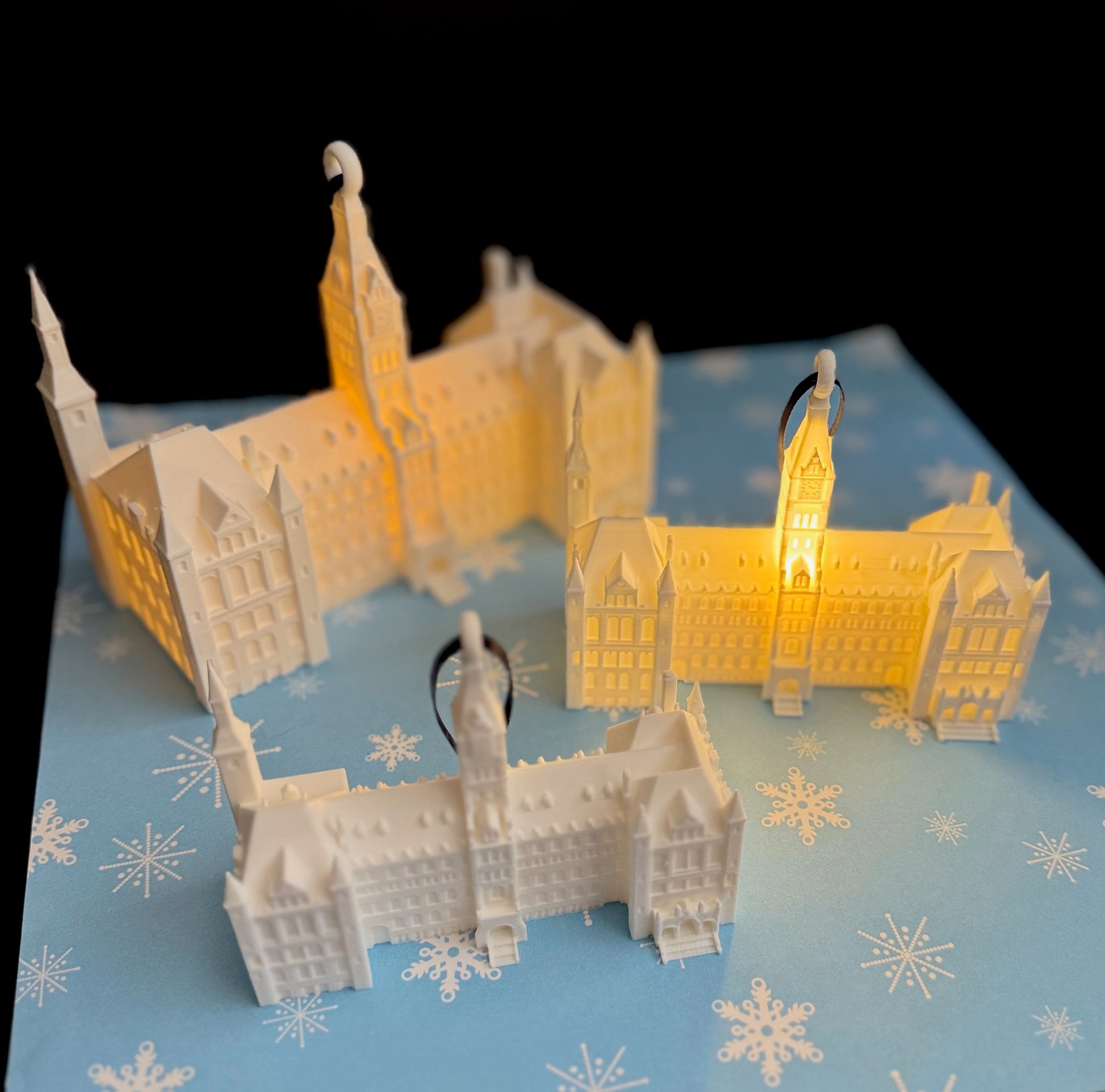 The Georgetown Healy Hall ornaments with LED lights, shown as a collection of keepsake gifts for Hoyas alumni.