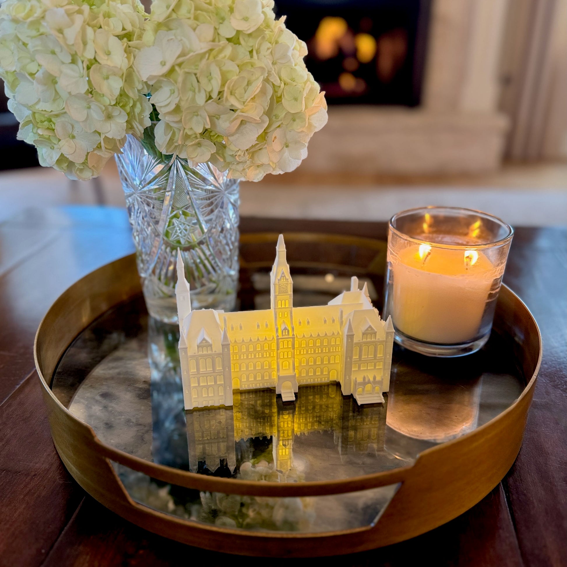 The Healy Hall light, used as dorm decor and shown styled on a tray in a living room.