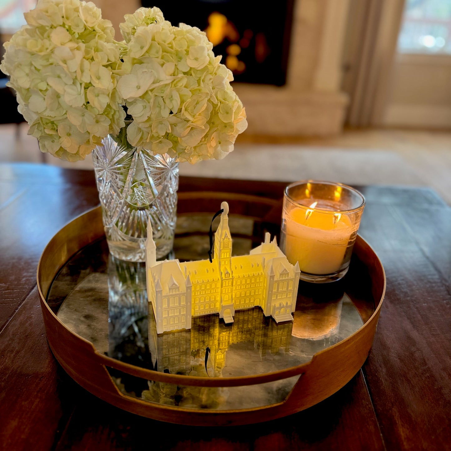 The lighted Georgetown University Ornament featuring Healy Hall, shown in a home decorated for Christmas.