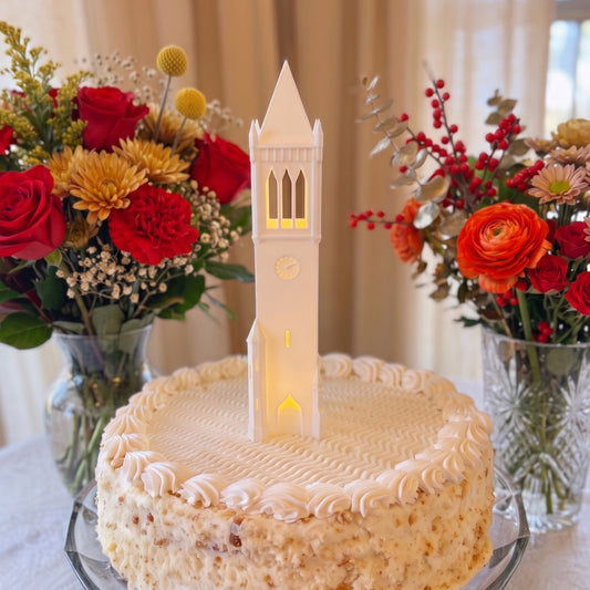 Lighted Iowa State University Campanile figurine sitting on top of a graduation party cake or a groom's cake.