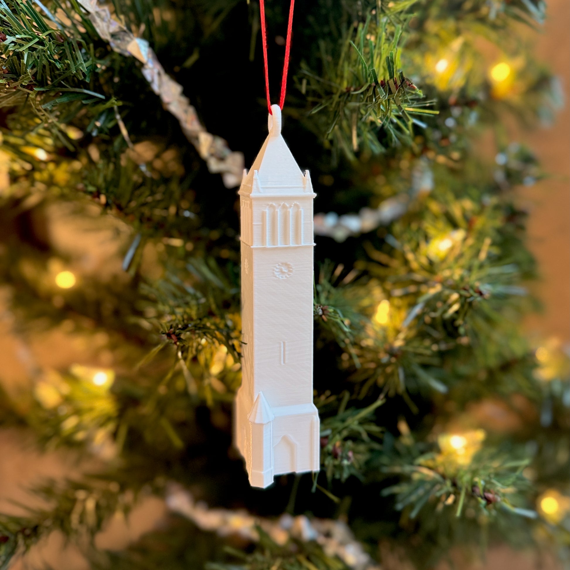 The Iowa State Campanile Ornament, shown on a Christmas tree.