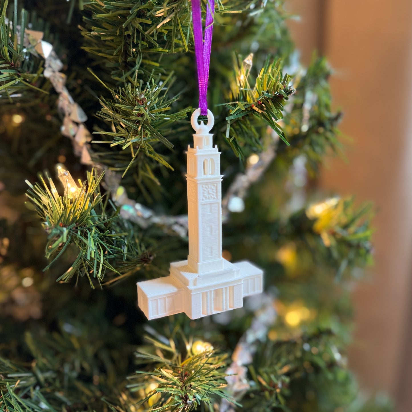 The LSU ornament depicting the Memorial Tower and shown on a Christmas tree.