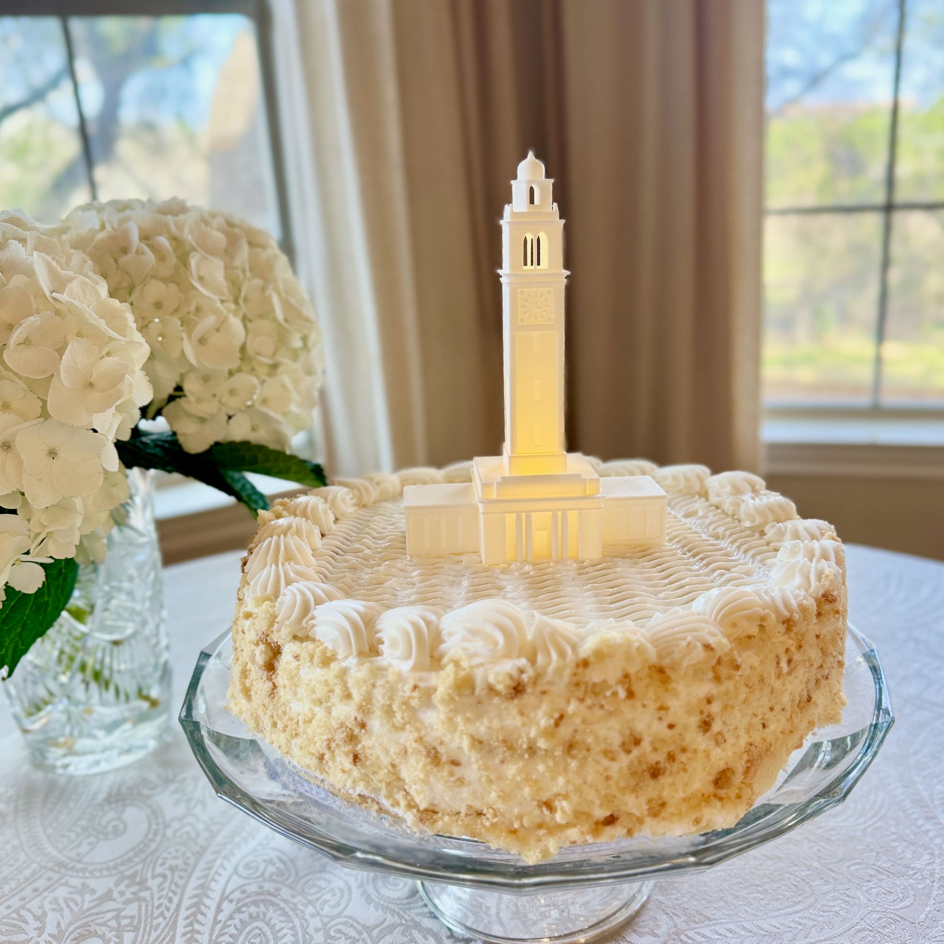The LSU cake topper, shown on a graduation cake at a party.