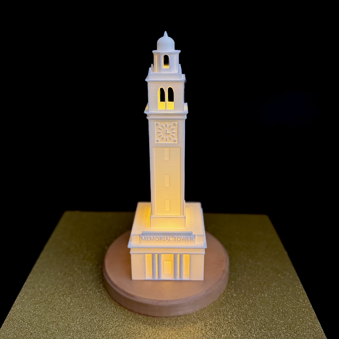 The LSU lamp, shown against a gold background and used as an alumni gift.