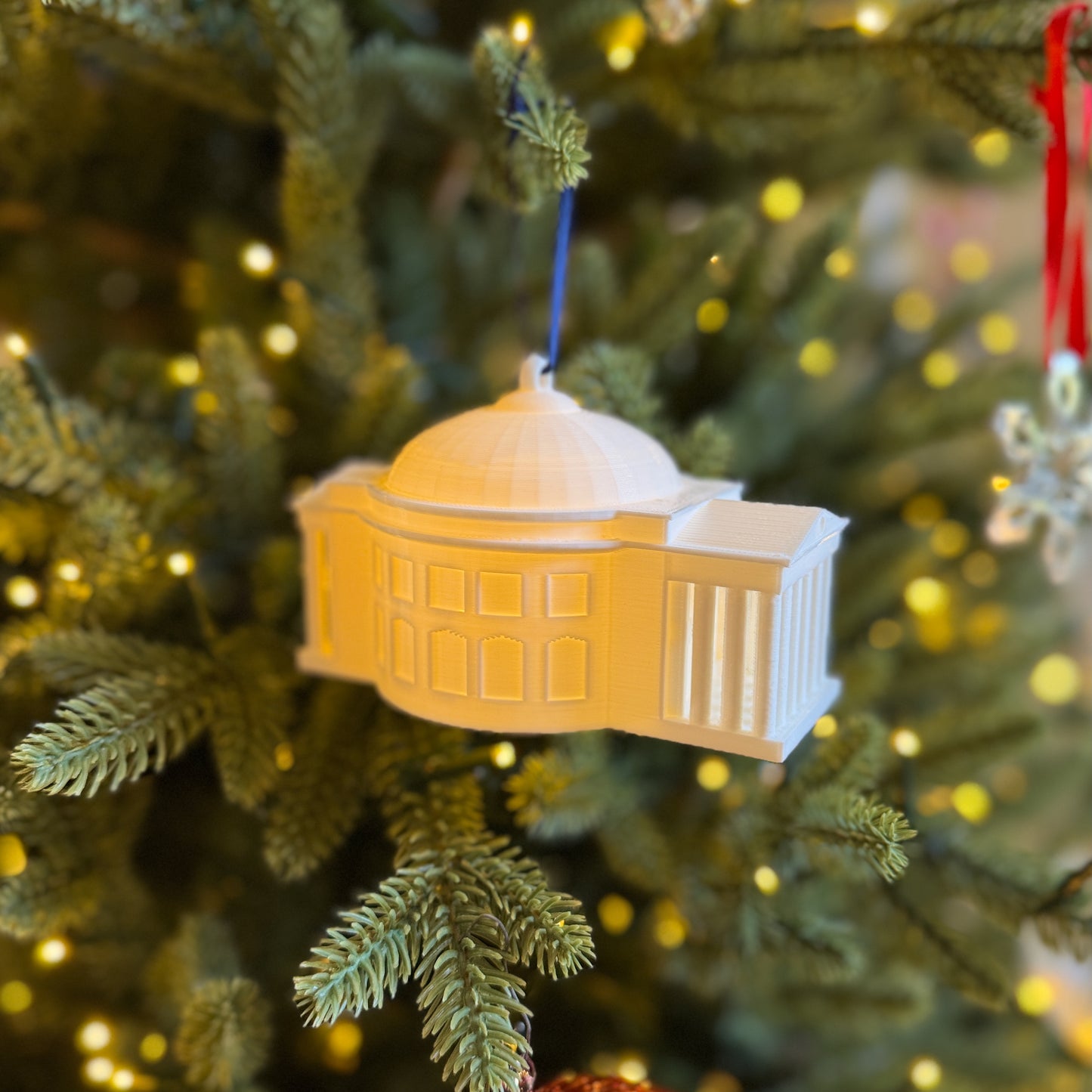 Side view of the UVA Rotunda ornament, shown on a Christmas tree.