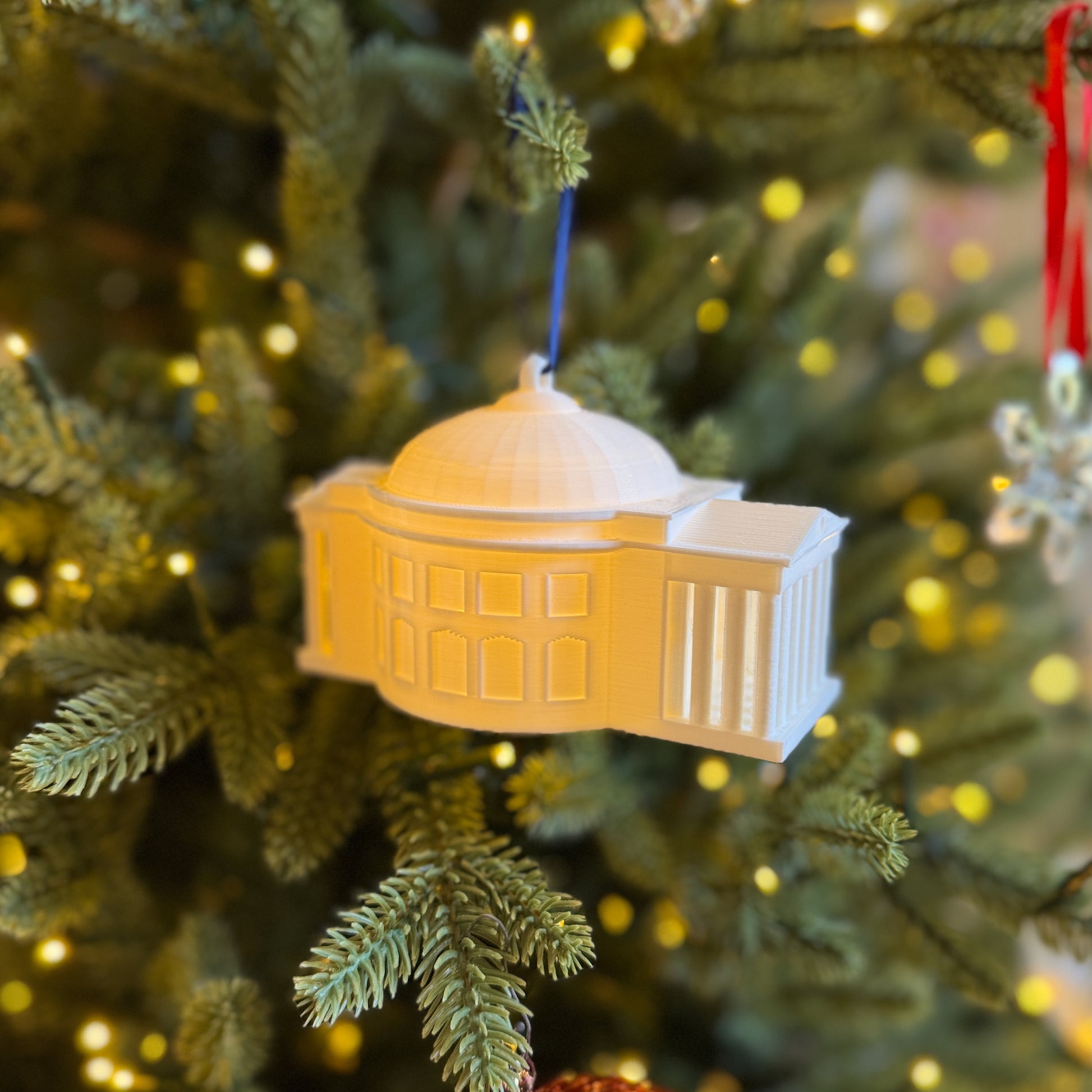 Side view of the UVA Rotunda ornament, shown on a Christmas tree.