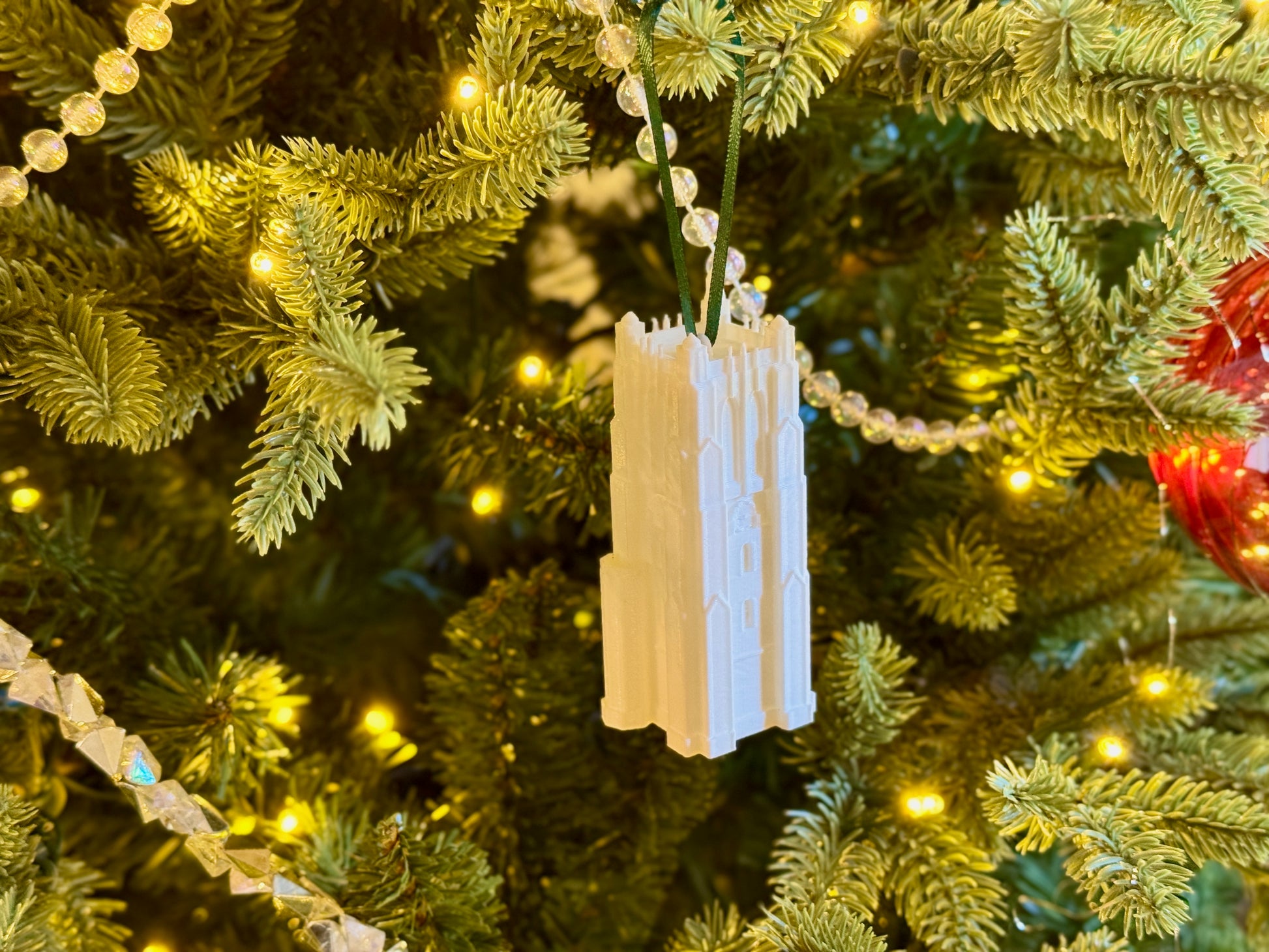 Michigan State Christmas ornament designed as the Beaumont Tower and shown on a tree.