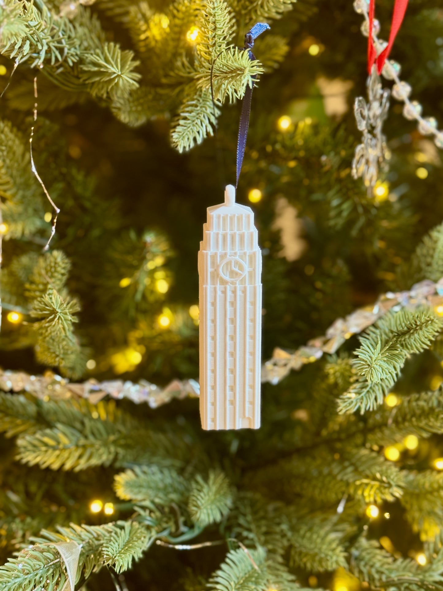 The Michigan Wolverines ornament featuring Burton tower, and shown on a UMich tree.
