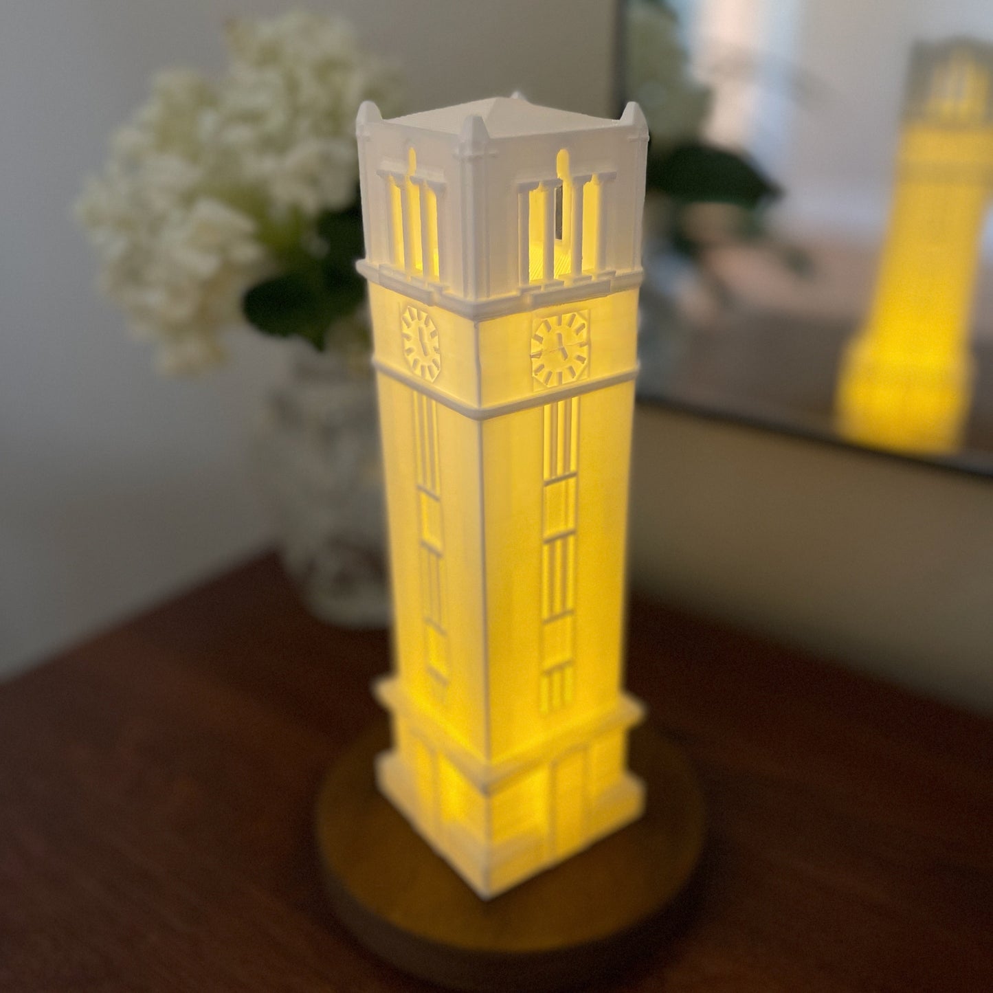 The larger NC State bell tower, shown in a dorm room.