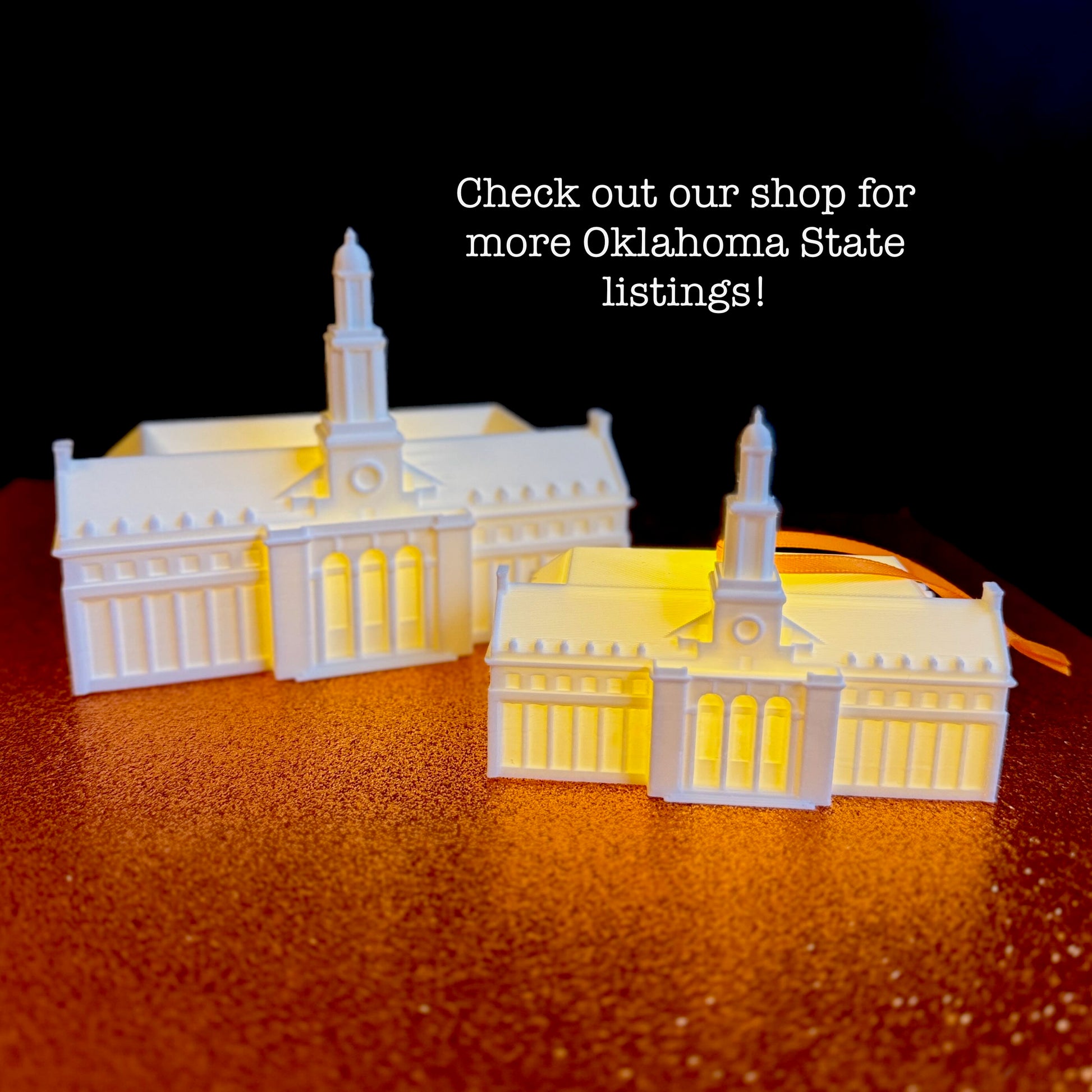 Battery-powered miniature Edmon Low Library ornament with an orange ribbon for hanging.