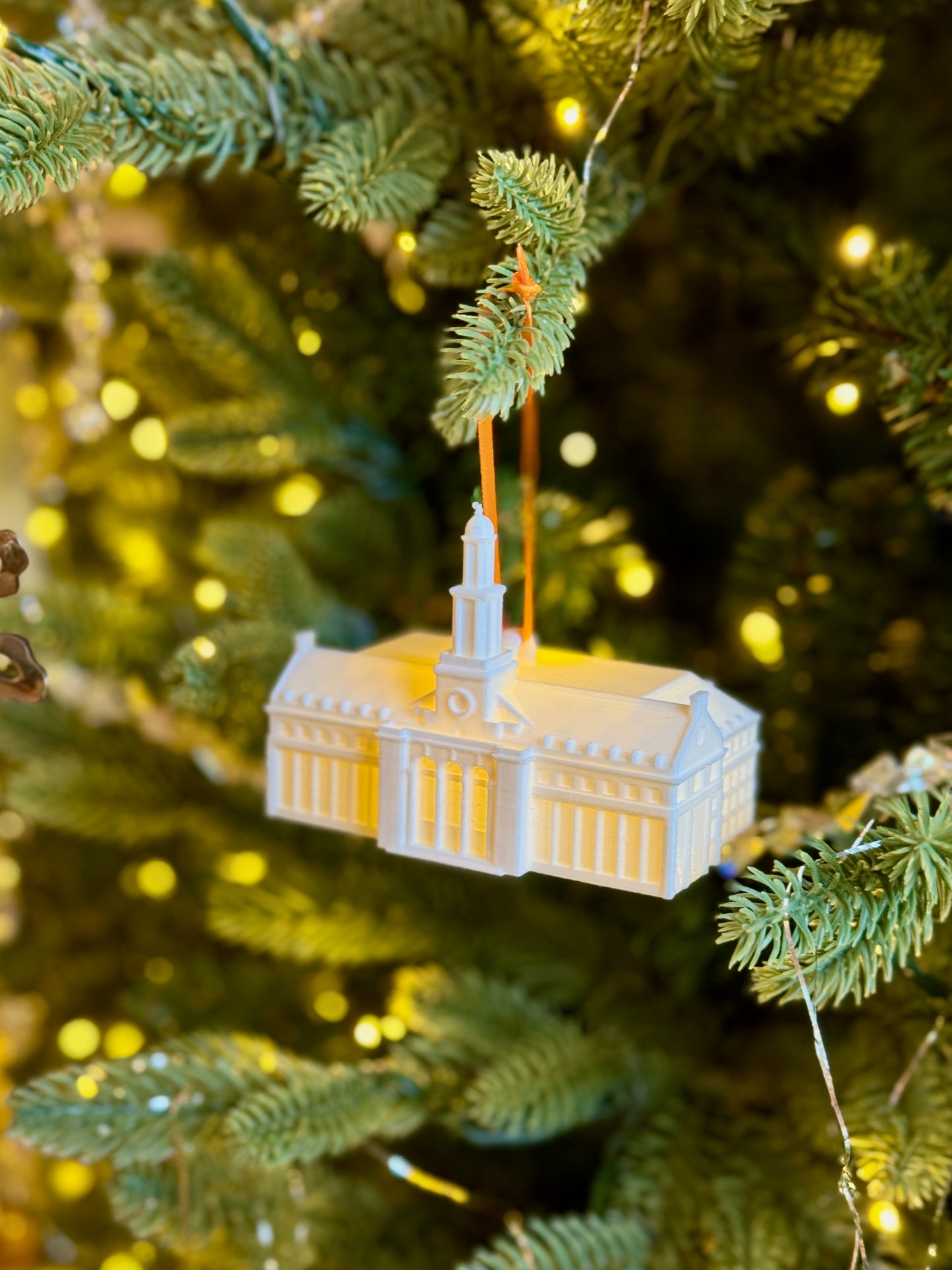 The Oklahoma State Sooners ornament of the Edmon Low Library, shown on a Christmas Tree