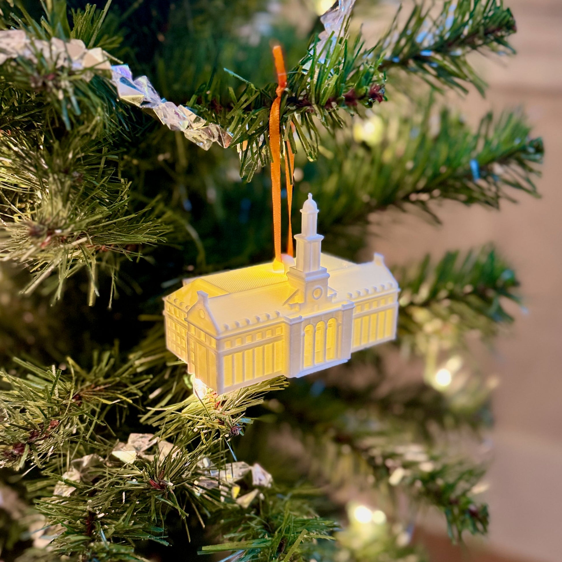 Warm white LED light glowing inside an Oklahoma State University library Christmas ornament.
