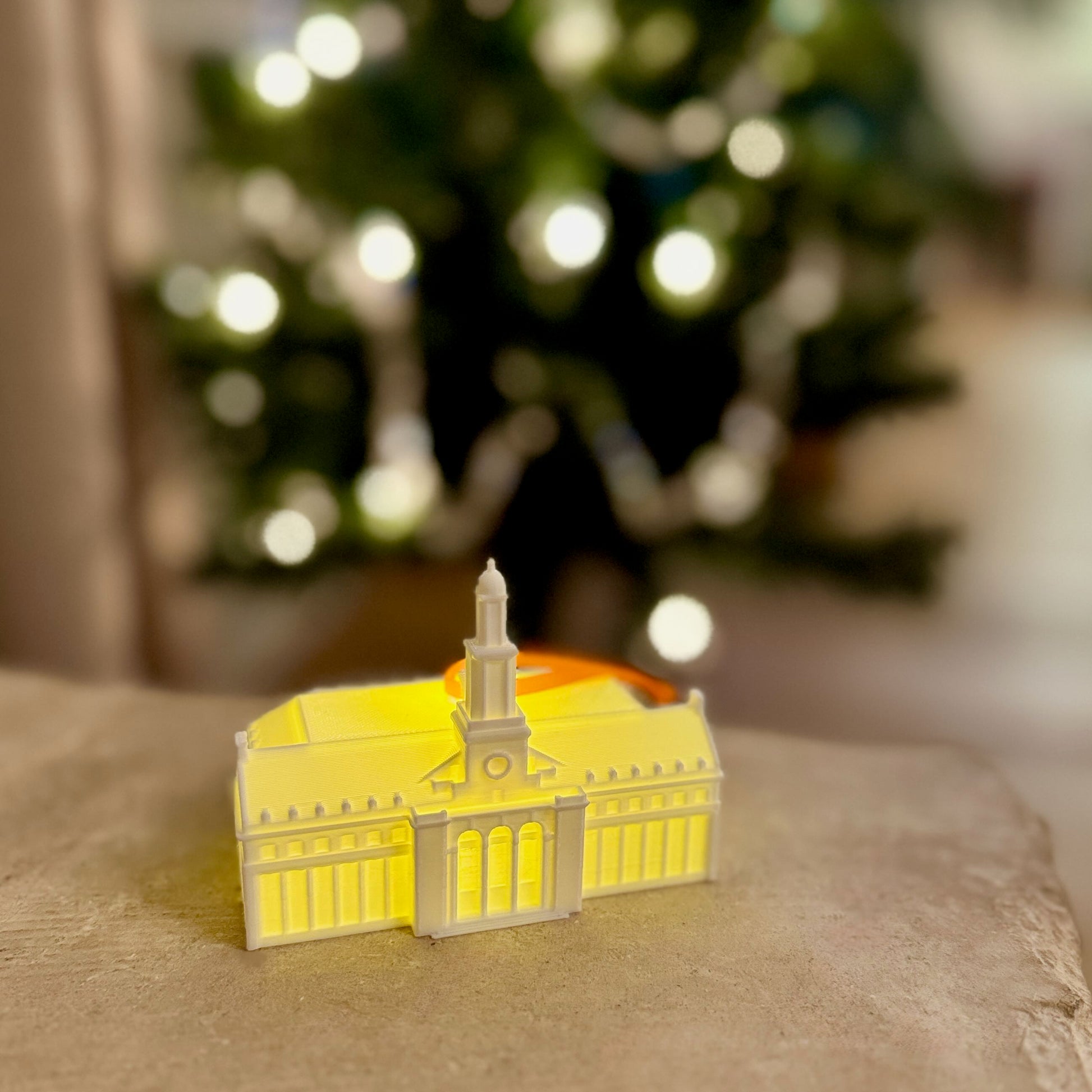 Edmon Low Library LED ornament shining brightly in a dimly lit room.