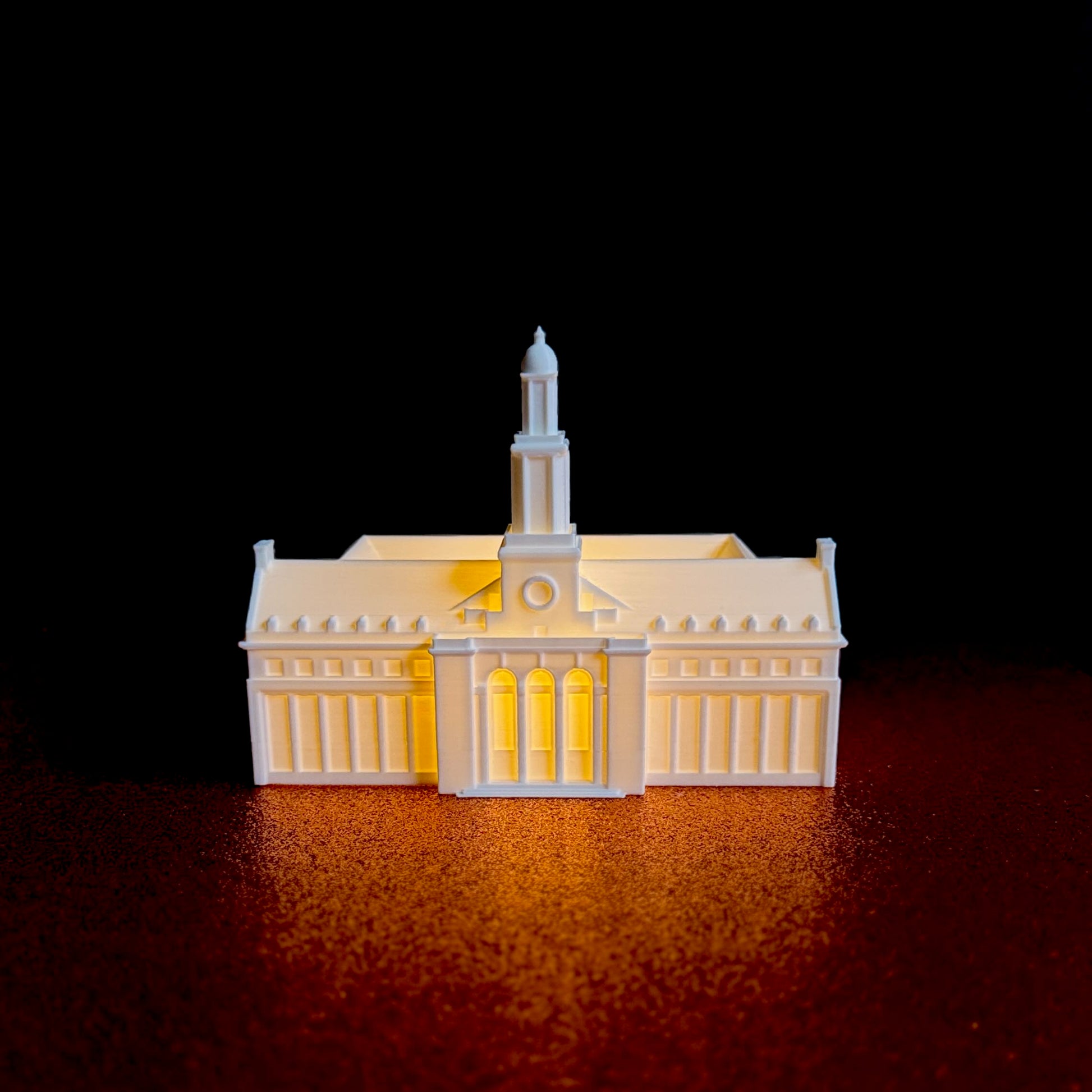 Battery-powered LED light illuminating a 3D printed Oklahoma State campus keepsake.