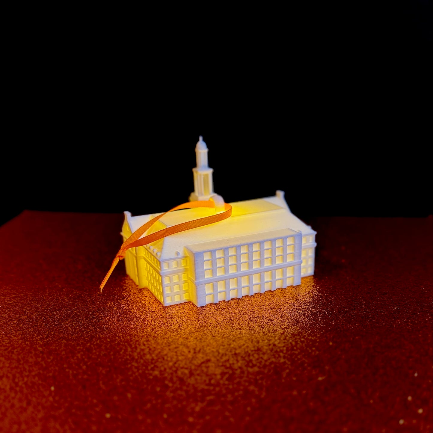Small PLA plastic 3D printed model of the Oklahoma State library used as a lighted tree ornament.
