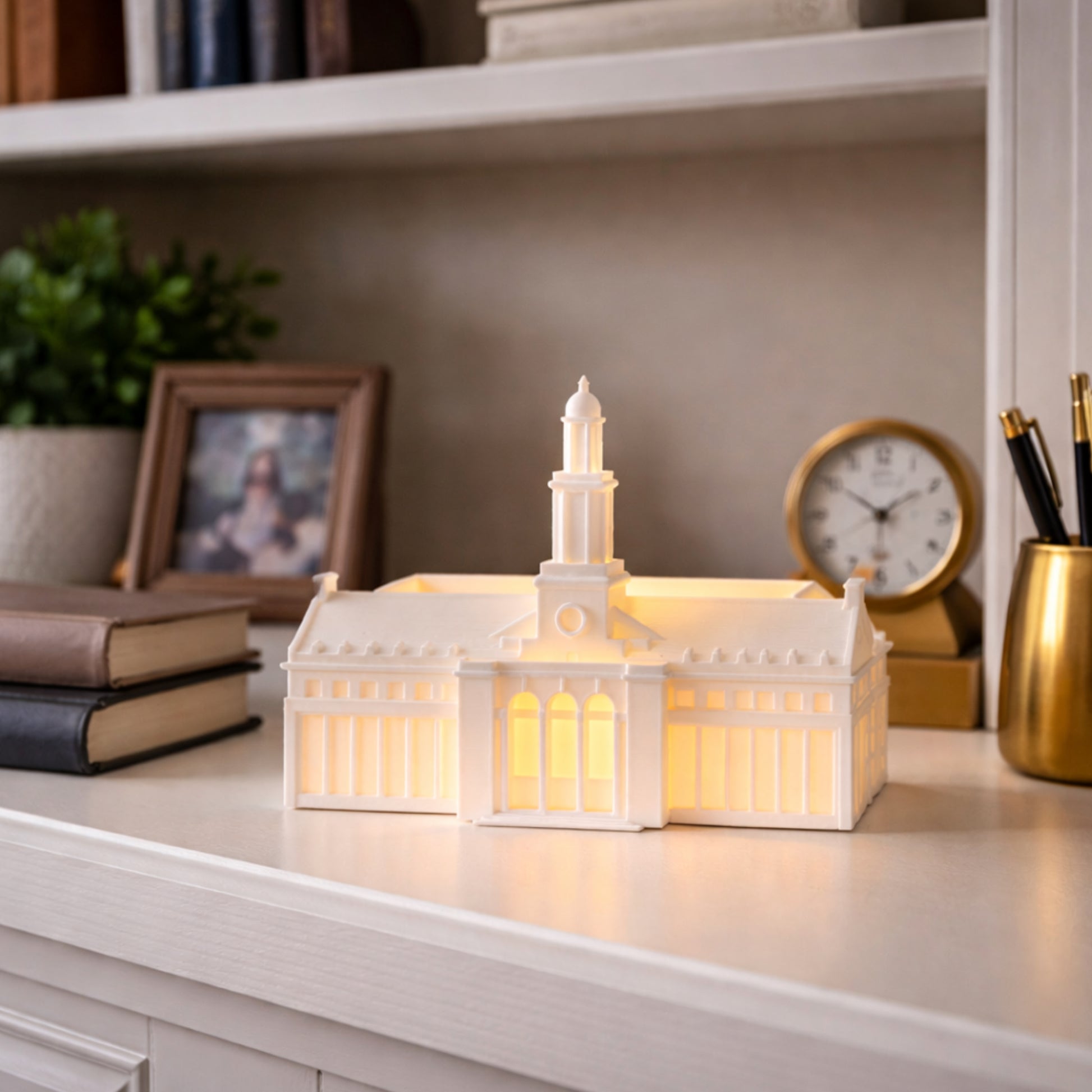 The OSU Edmon Low Library figurine with an LED light, used as Oklahoma State University office decor.