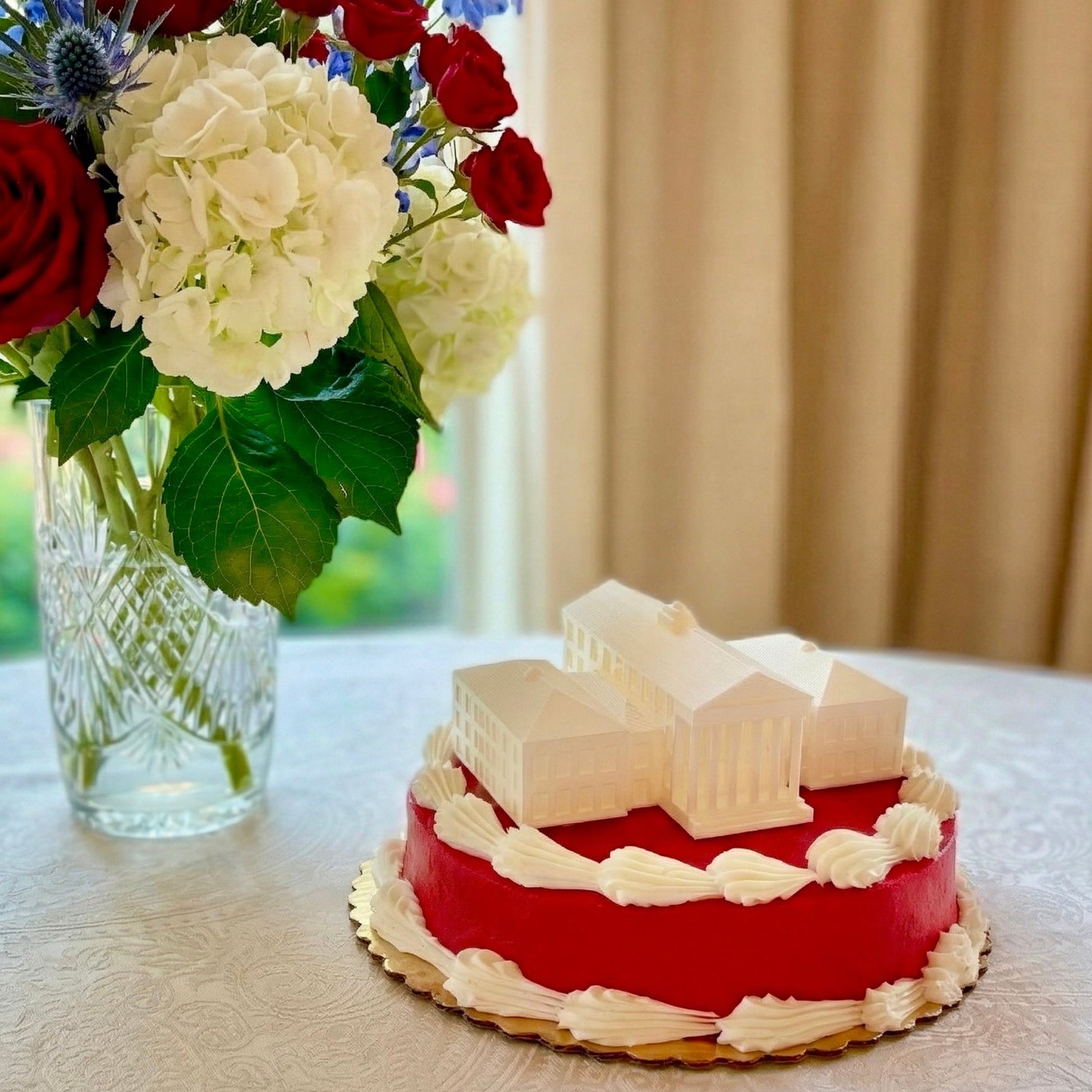 The Ole Miss cake topper designed with an LED light as a replica of the Lyceum building on the Oxford campus.
