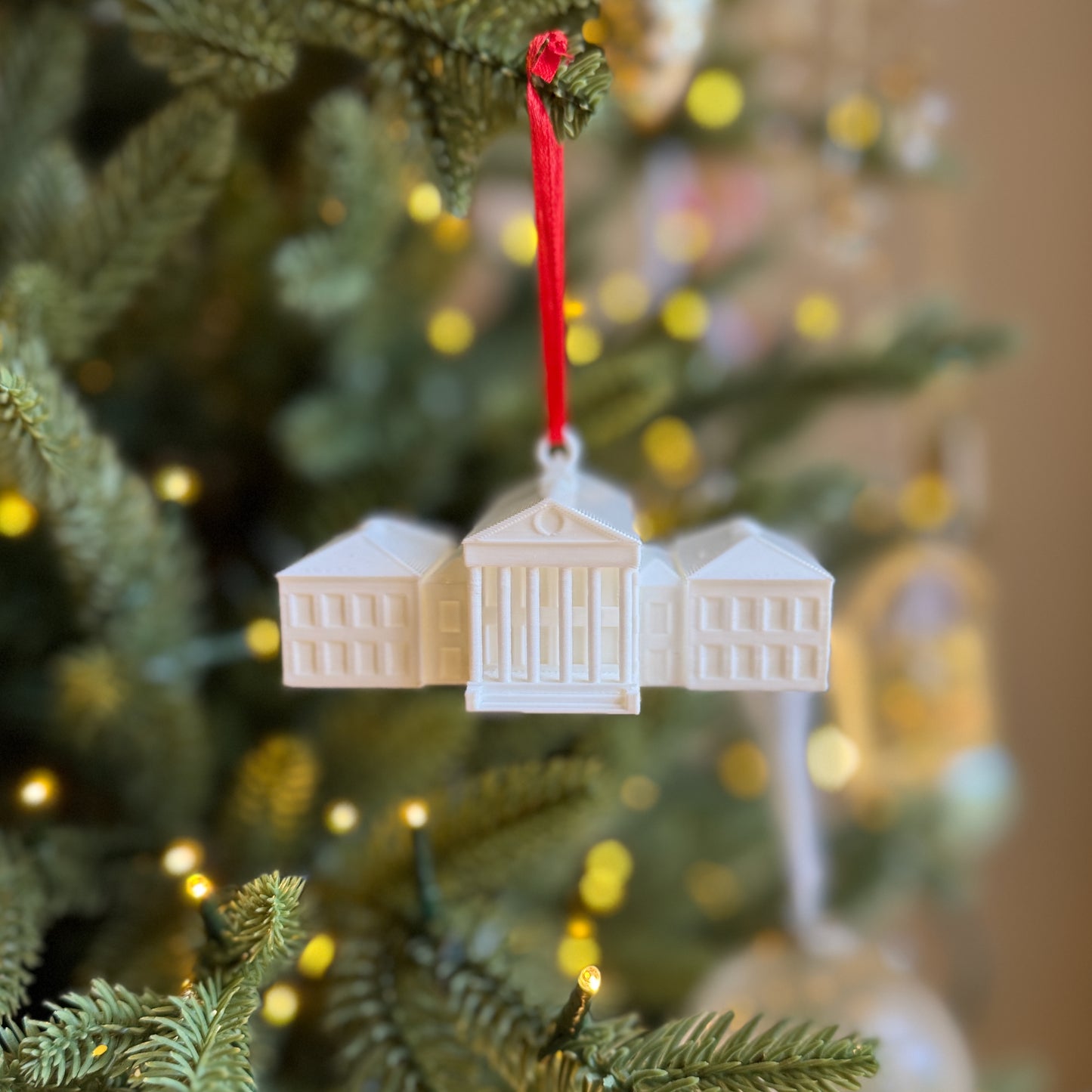 Front view of the Ole Miss ornament, designed as a replica of the Lyceum building on campus.