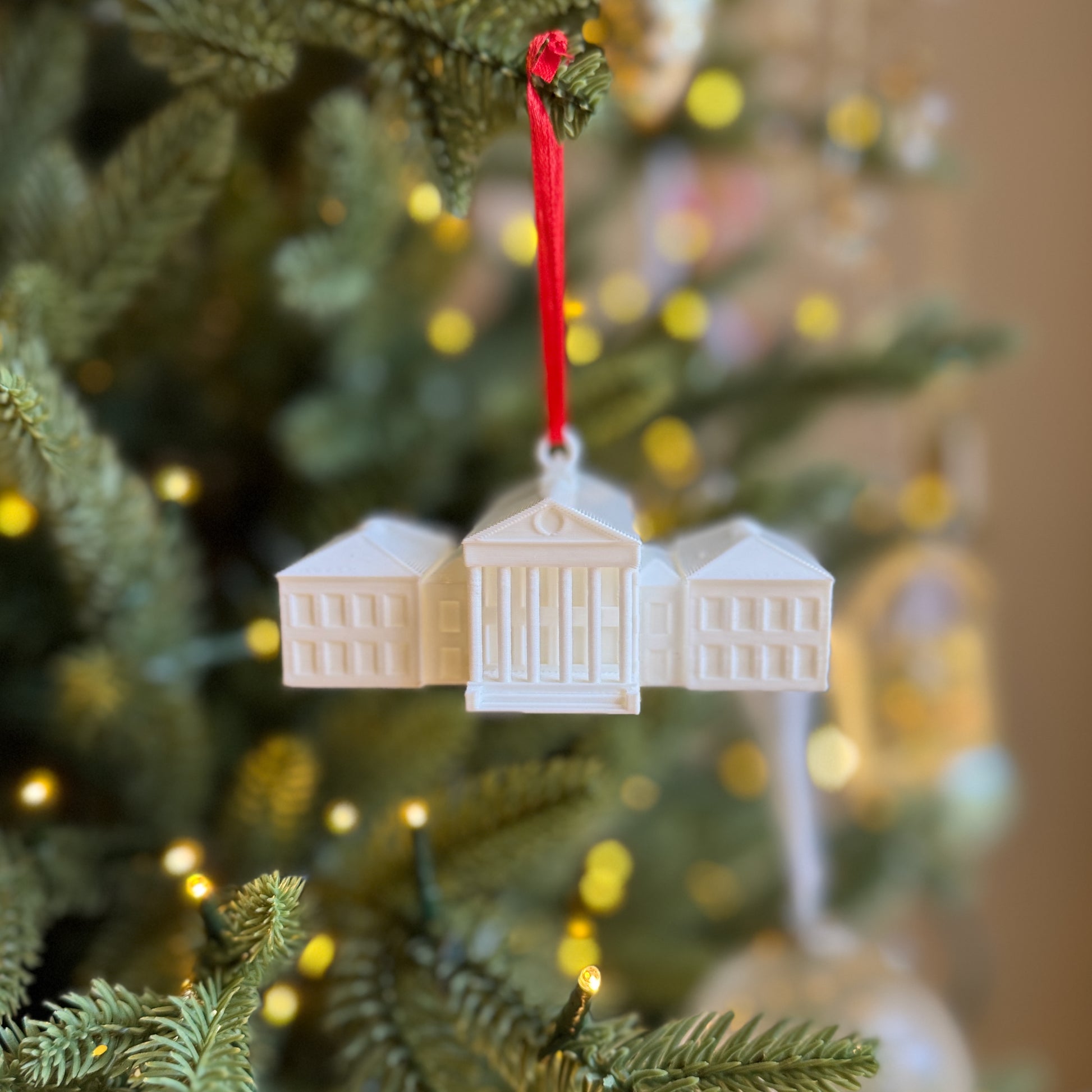 Front view of the Ole Miss ornament, designed as a replica of the Lyceum building on campus.