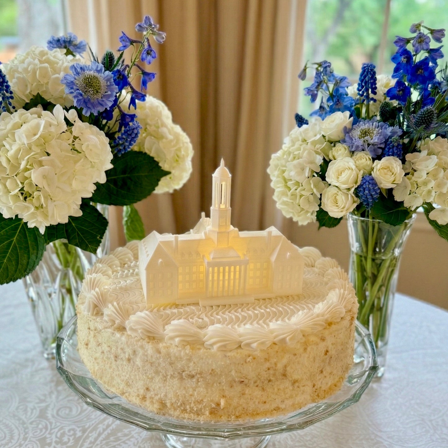 The Penn State cake topper figurine with an LED light, designed to look like the Old Main building on campus and shown on a groom's cake or graduation cake.