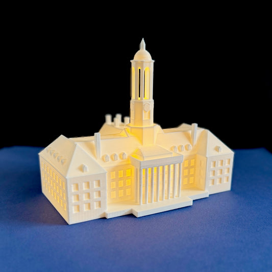 The Penn State light representing the Old Main building, shown against a blue background.