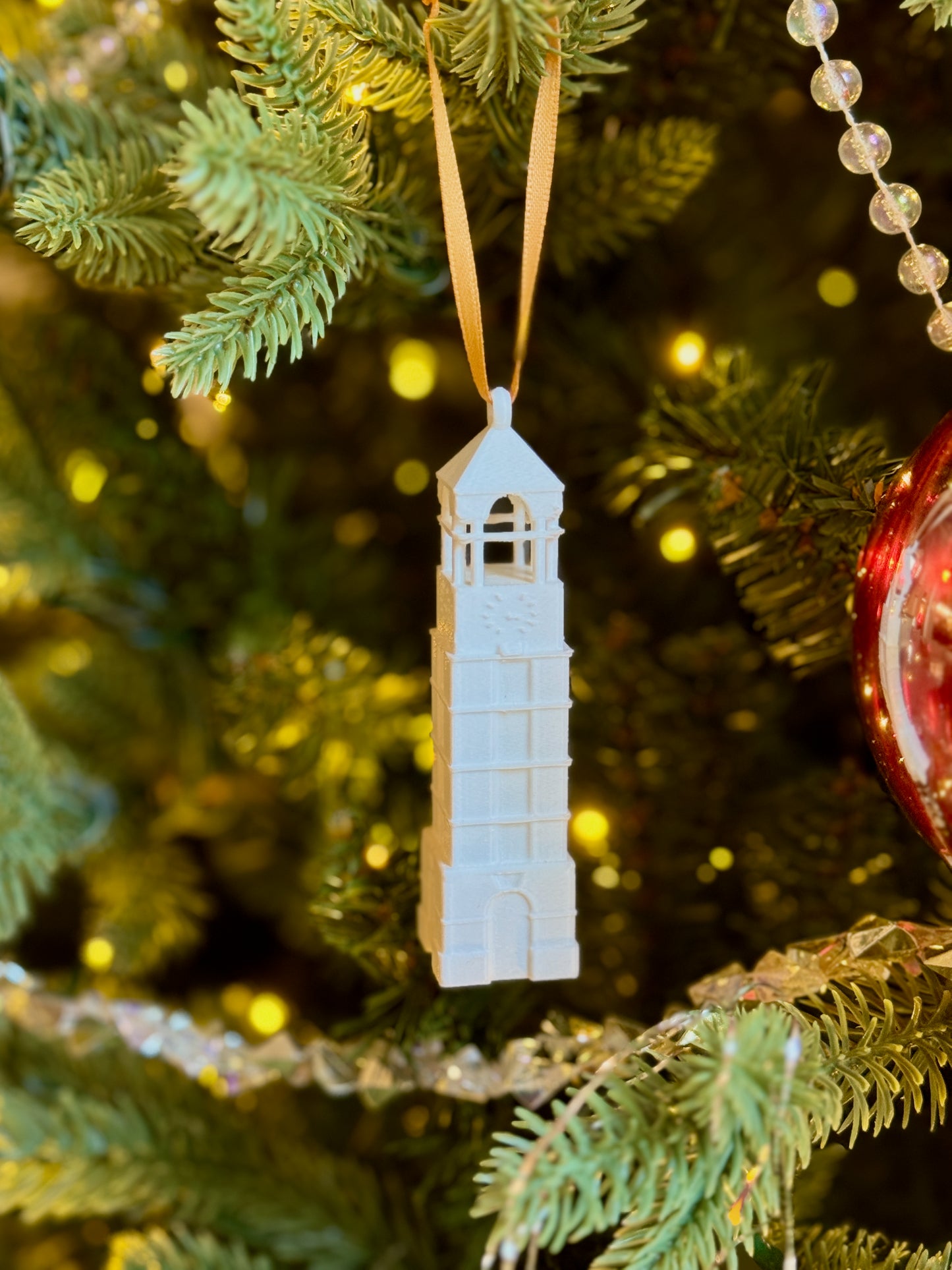 The Purdue bell tower ornament shown on a Boilermakers tree.