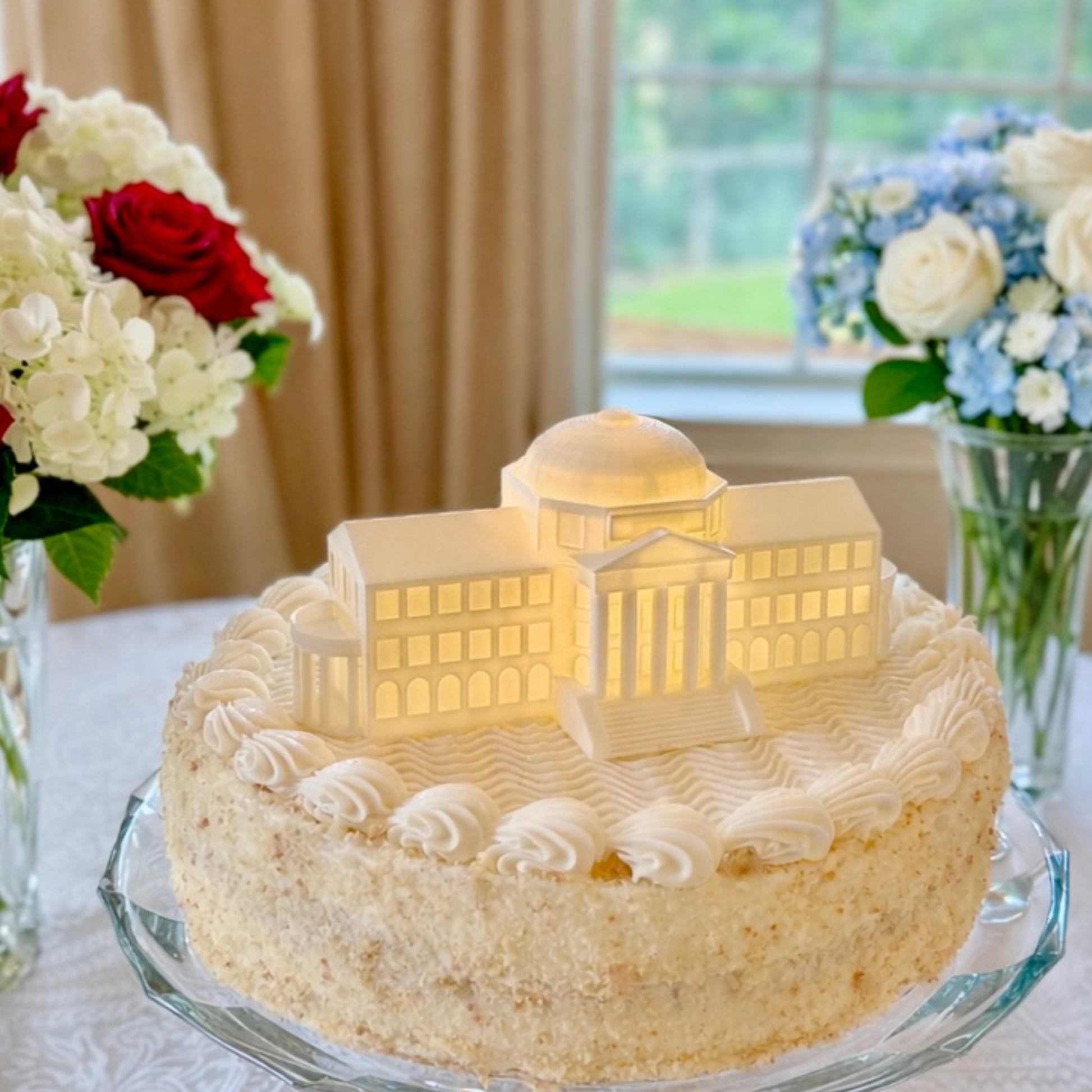 The SMU cake topper with LED light, designed as a replica of the Dallas Hall building and shown on a graduation cake or groom's cake.
