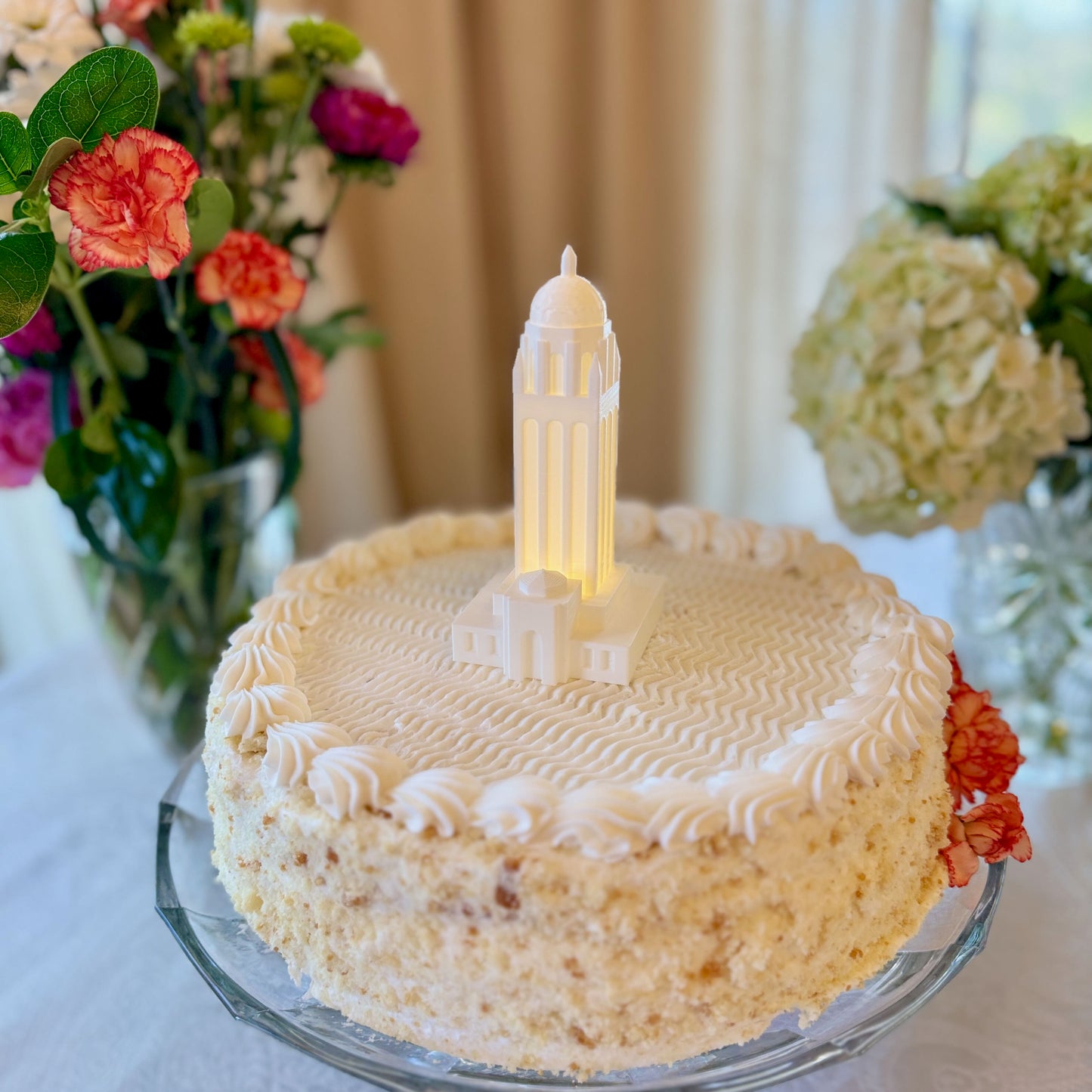 The Stanford University cake topper figurine featuring Hoover Tower, shown on a Stanford graduation cake.