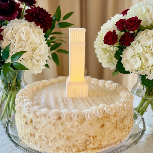 The Texas A&M cake topper light designed as a replica of the Albritton Tower building on campus and shown on a groom's cake or a gradation cake for an Aggie.
