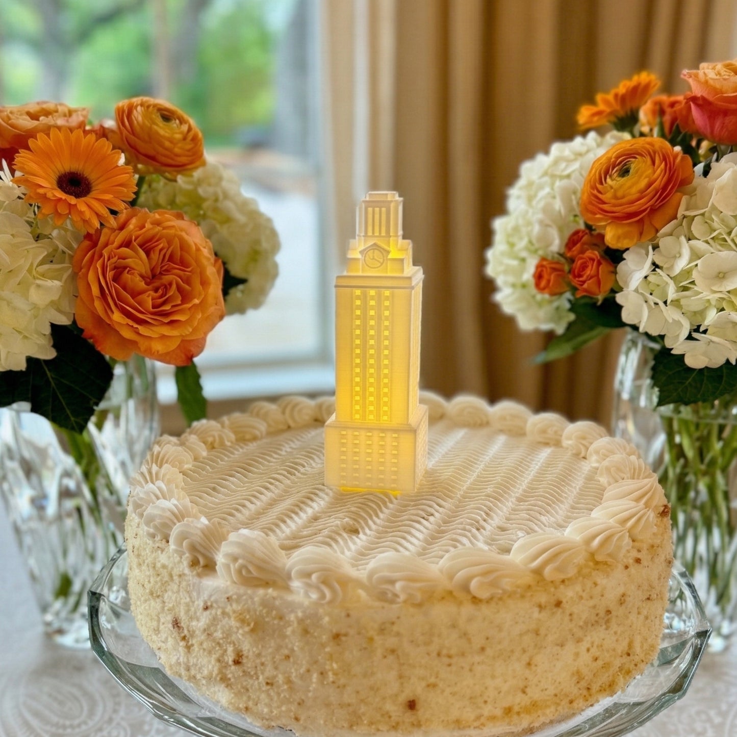 The white University of Texas UT Tower figurine used as a cake topper and shown on a UT groom's cake.