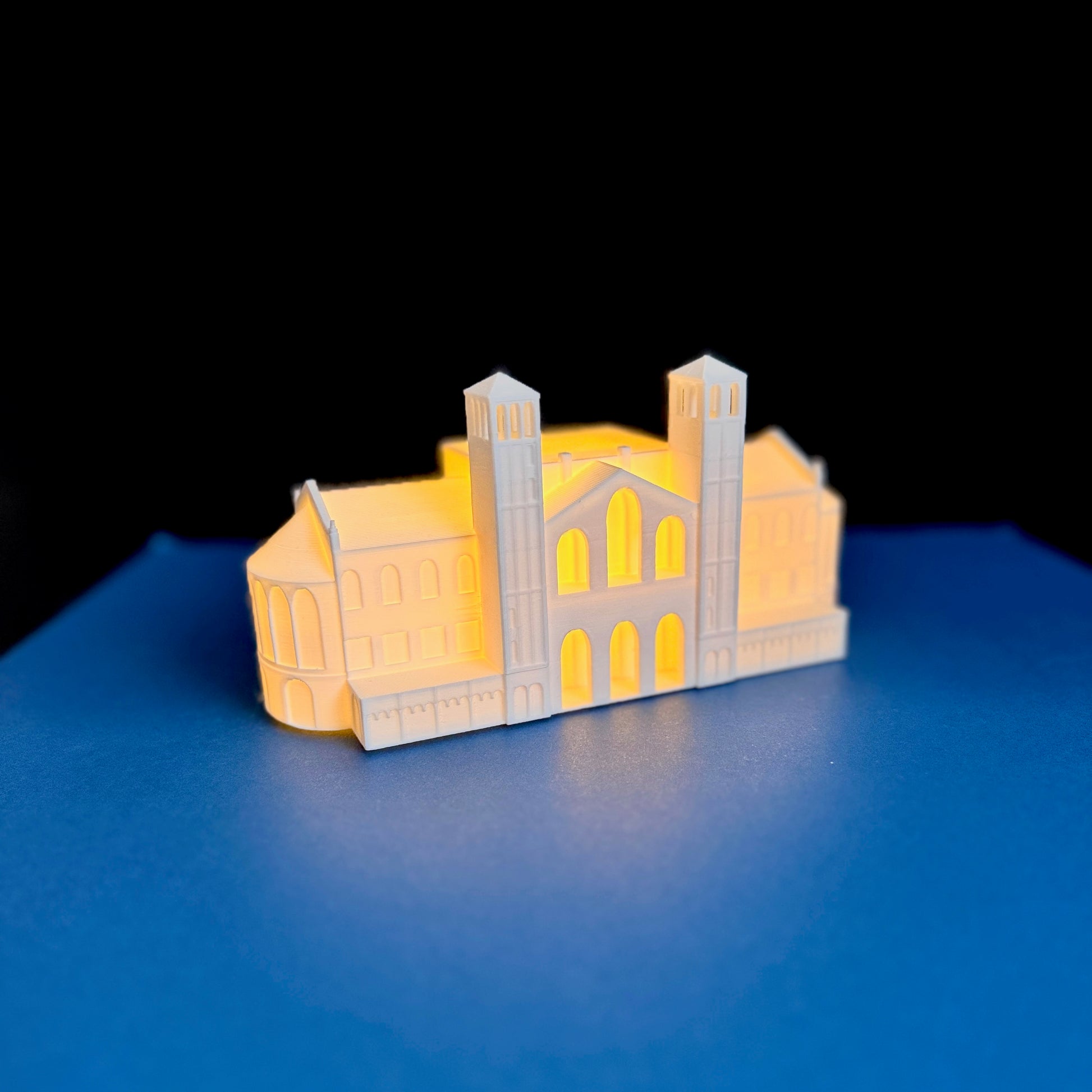 The UCLA Royce Hall lighted figurine, shown illuminated against a blue background.