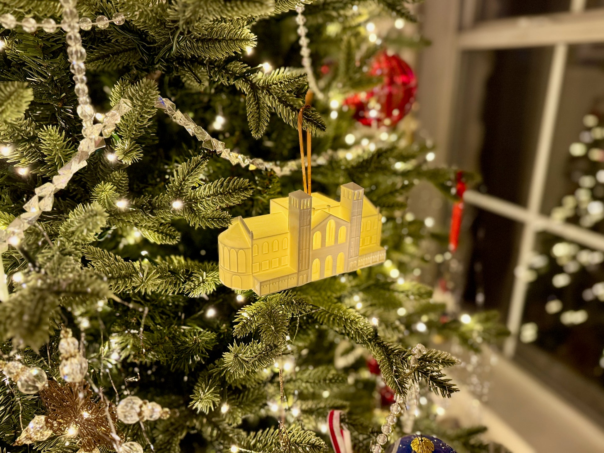 The UCLA Royce Hall ornament on a Christmas tree.