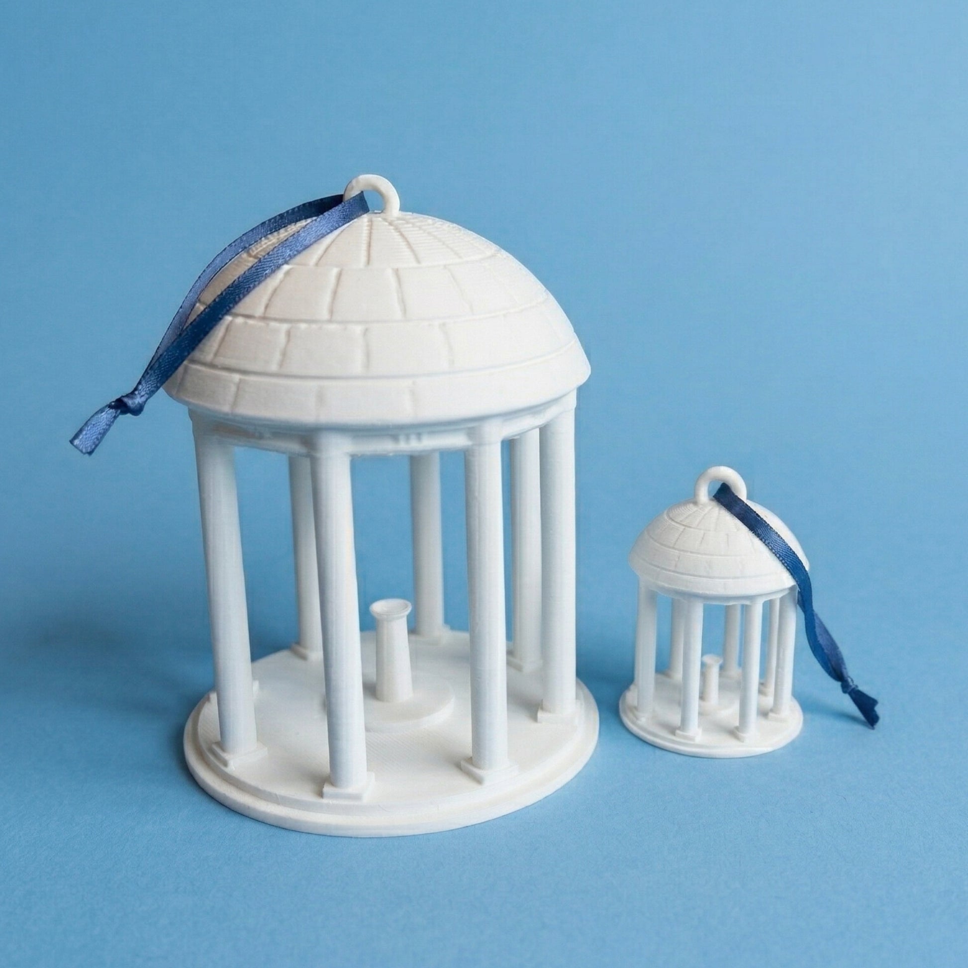 The UNC Chapel Hill ornaments representing the Old Well on campus and shown side by side.