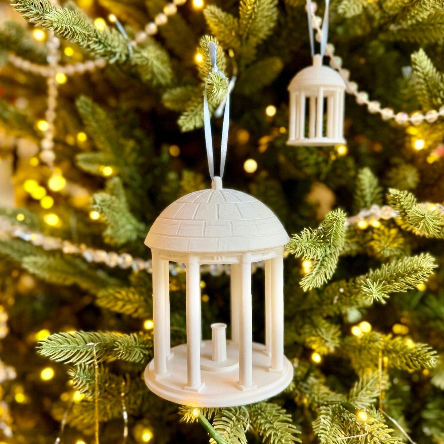 The UNC Old Well ornaments, shown on the Christmas tree of a Tar Heels fan.