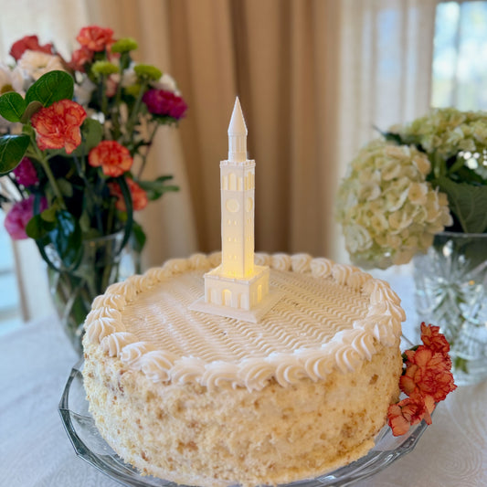 The lighted UNC Tower Cake topper, shown on a UNC graduation cake.