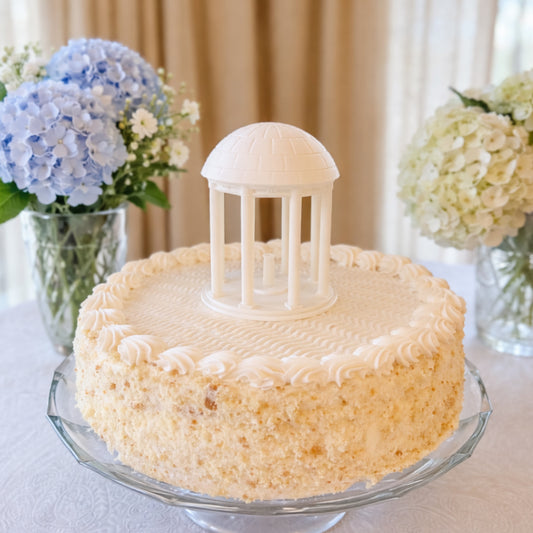 The UNC Old Well cake topper, shown on a graduation cake for University of North Carolina alumni.