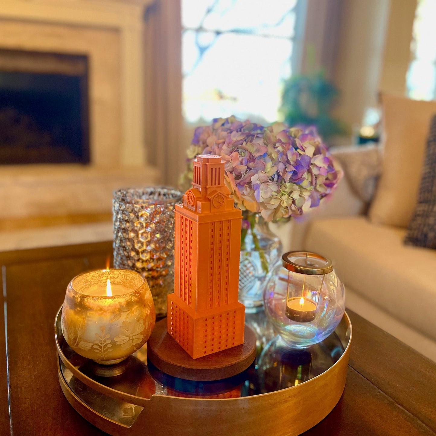 The burnt orange UT tower light, used as home decor and shown on a living room tray.