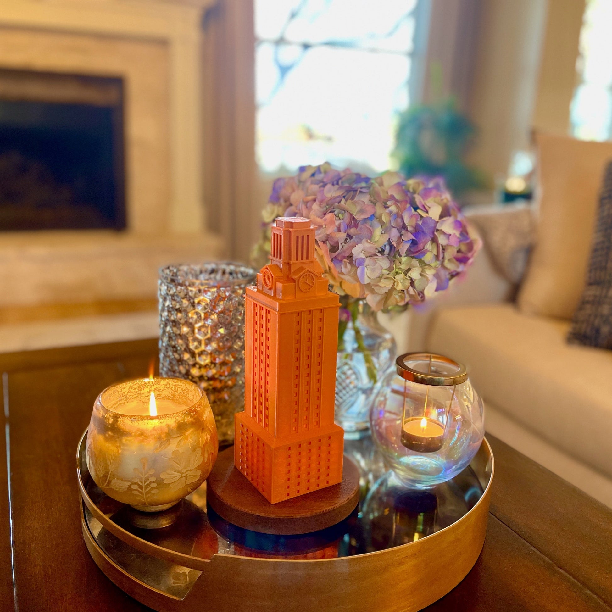 The burnt orange UT tower light, used as home decor and shown on a living room tray.