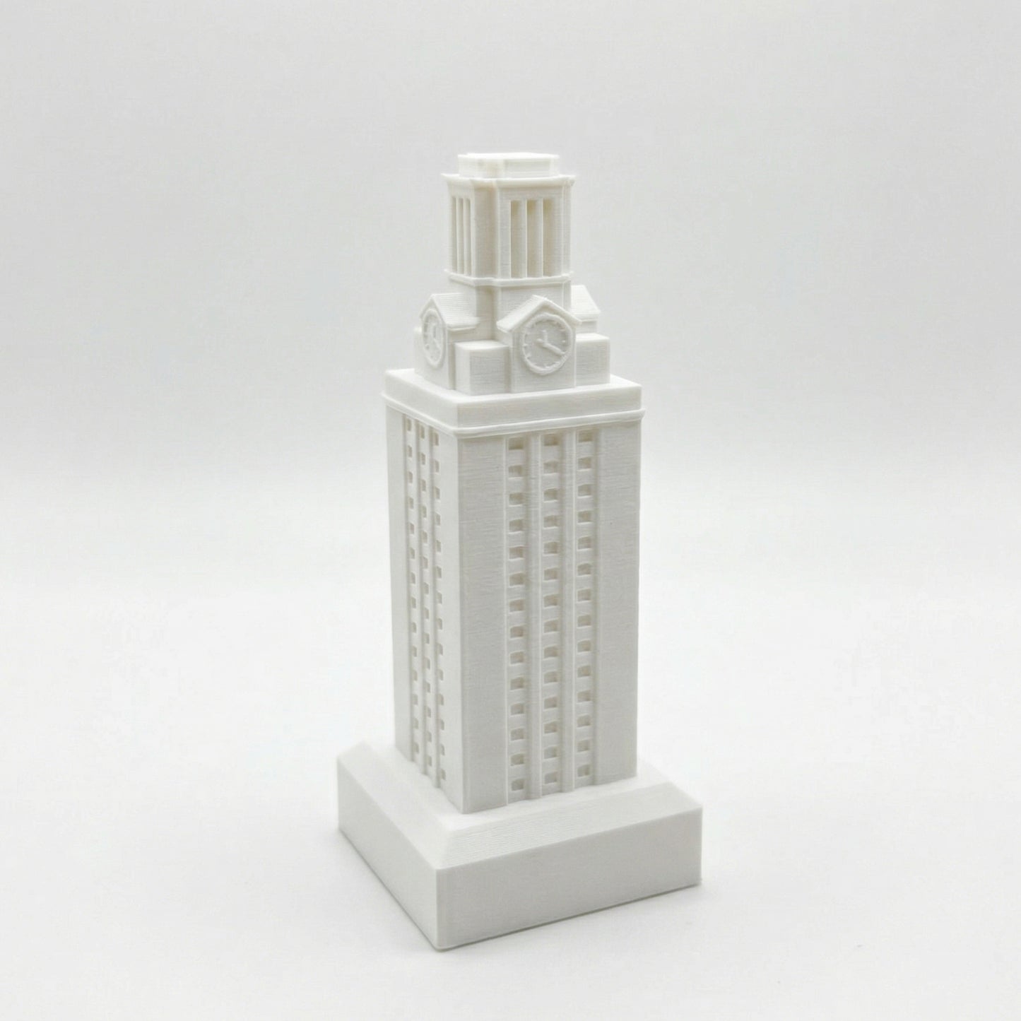 The University of Texas Tower figurine, shown in white against a studio background.