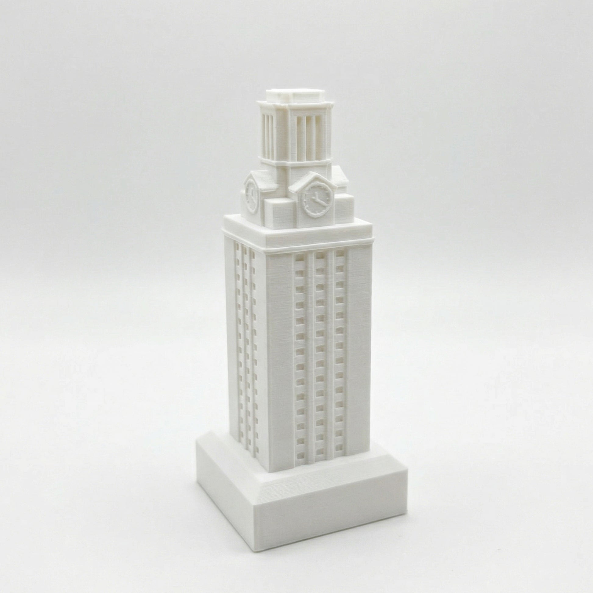 The University of Texas Tower figurine, shown in white against a studio background.