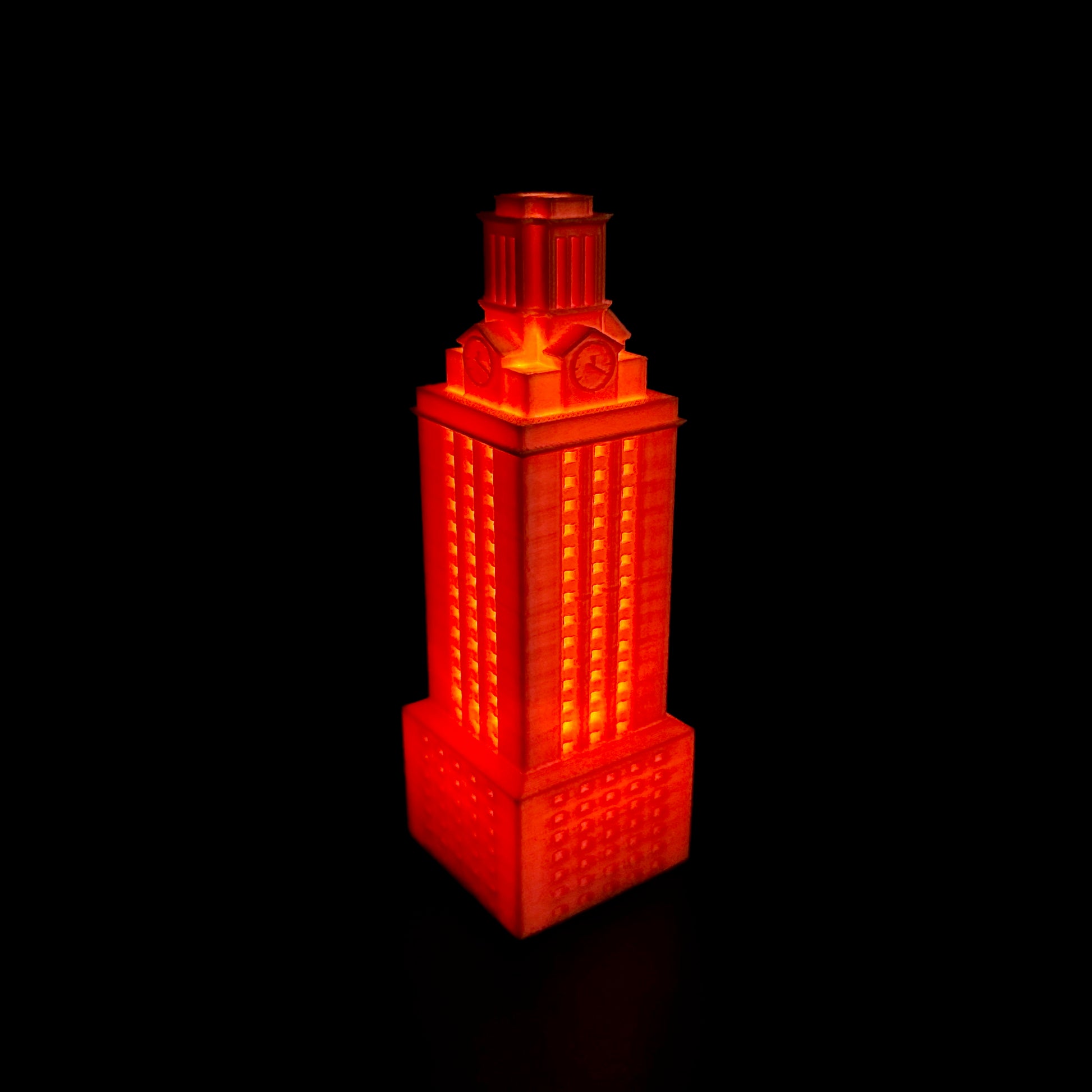 The lighted University of Texas Tower figurine, shown in orange and used as Texas Longhorns decor.
