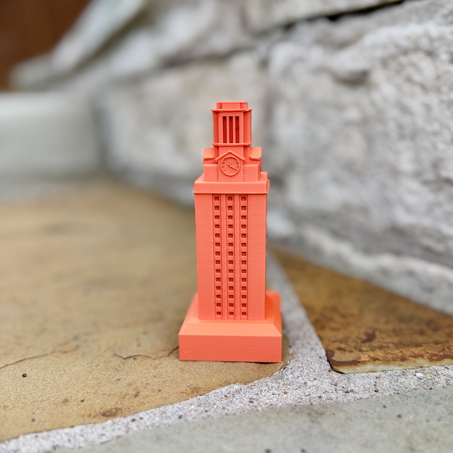 Detailed 3D printed UT Tower miniatures inspired by the University of Texas Austin landmark.