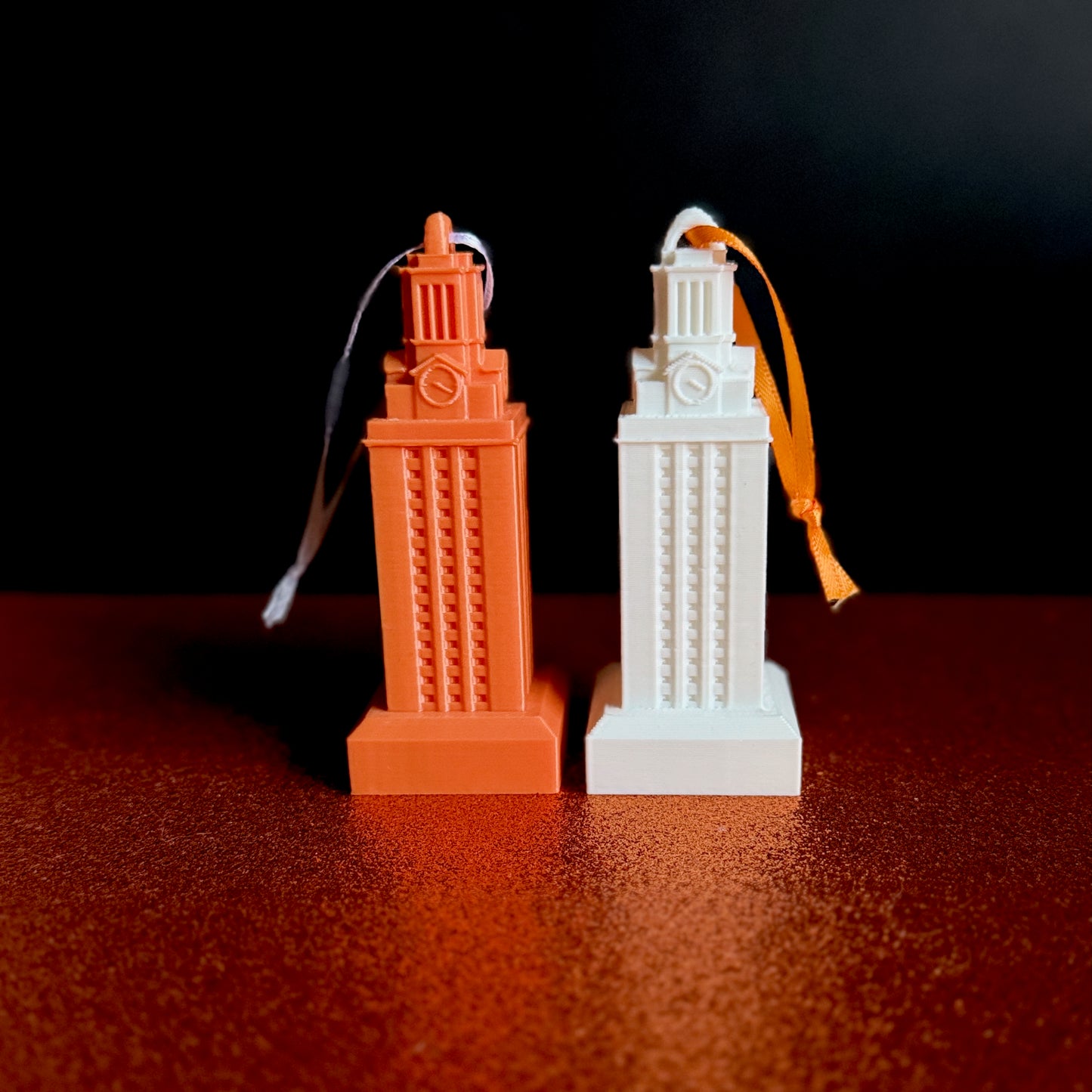 The UT Tower ornaments shown side by side.