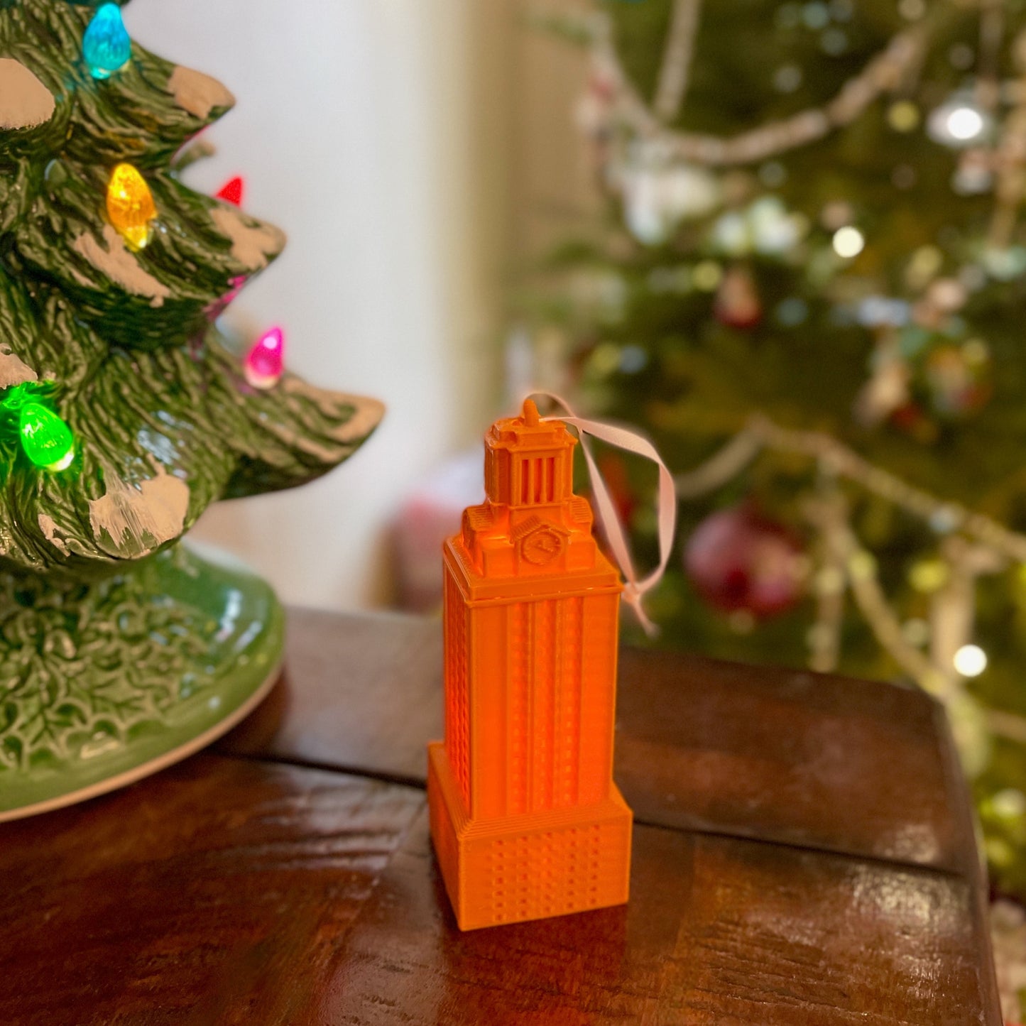 The University of Texas burnt orange UT Tower ornament, shown in a home decorated for Christmas.