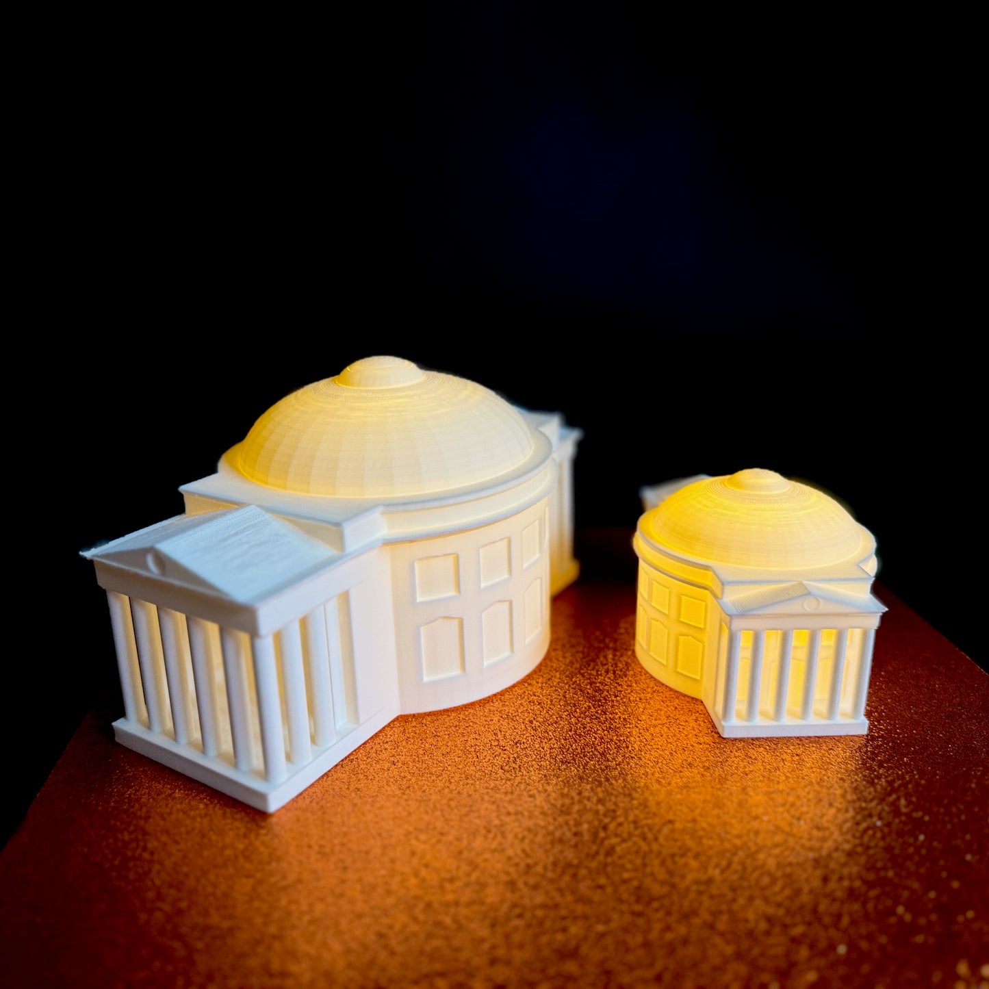 Two UVA keepsake figurines, shown side by side.