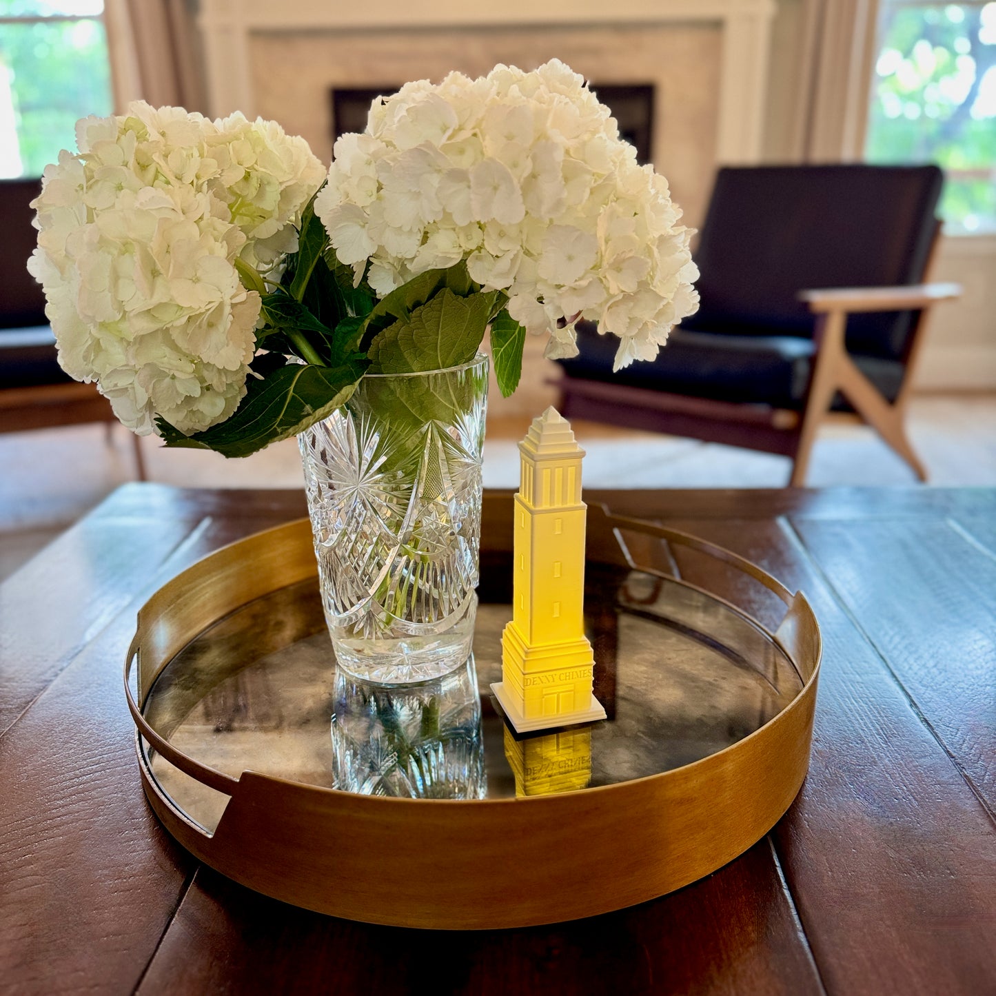 The Denny Chimes LED light, perfect as a University of Alabama Alumni Gift, and shown as a home decor item on a living romm tray.